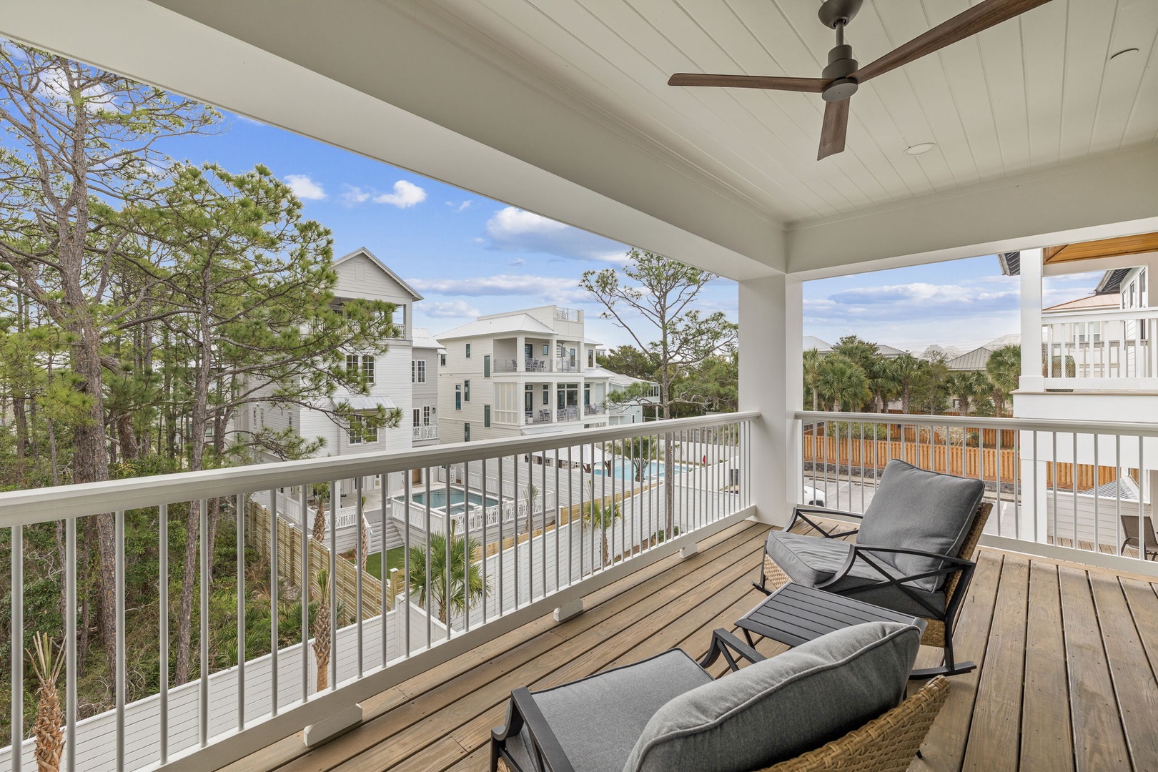 Relax on your private covered balcony with comfortable seating and peaceful neighborhood views. The ceiling fan keeps you cool while you unwind.