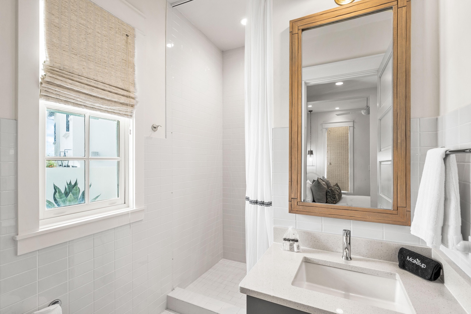 Step into your beautifully appointed bathroom featuring crisp white tiles, warm wood accents, and thoughtful touches that make your stay feel like home.