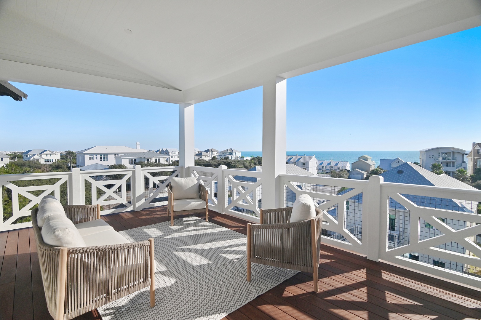 Soak up coastal breezes on your private covered balcony, where elegant seating invites you to relax and savor stunning sea views. Watch sailboats glide by as the sun warms this serene, open-air retreat.