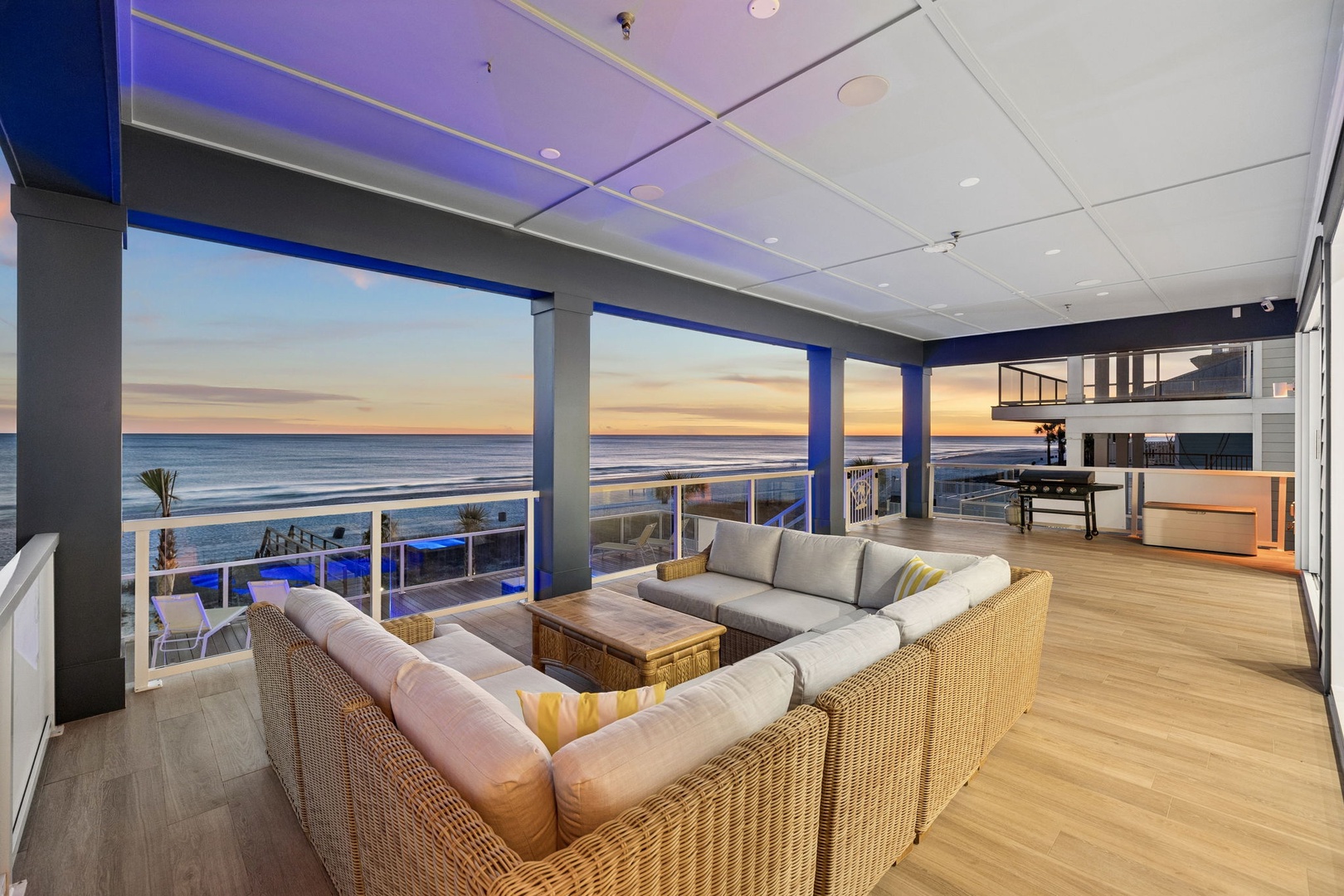 Unwind in your stunning oceanfront living room as sunset paints the sky, with plush seating perfect for watching waves roll in.