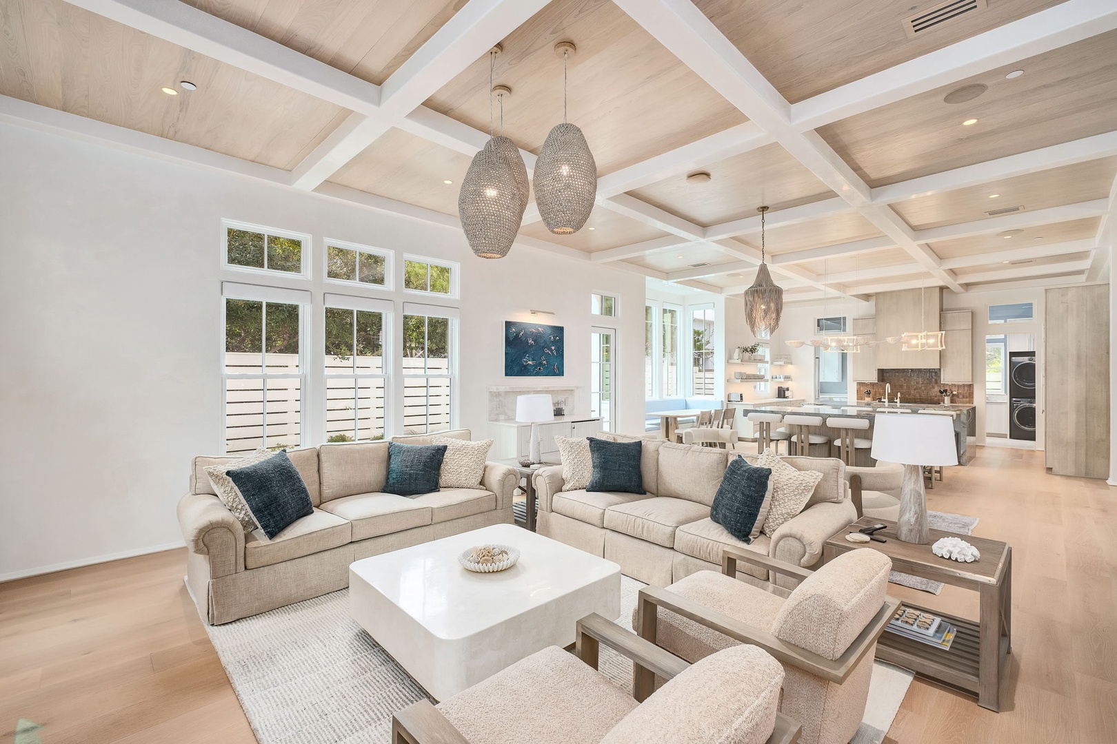 Settle into your open-concept living space where soaring wood-beamed ceilings and coastal-inspired décor create the perfect backdrop for relaxation and togetherness.