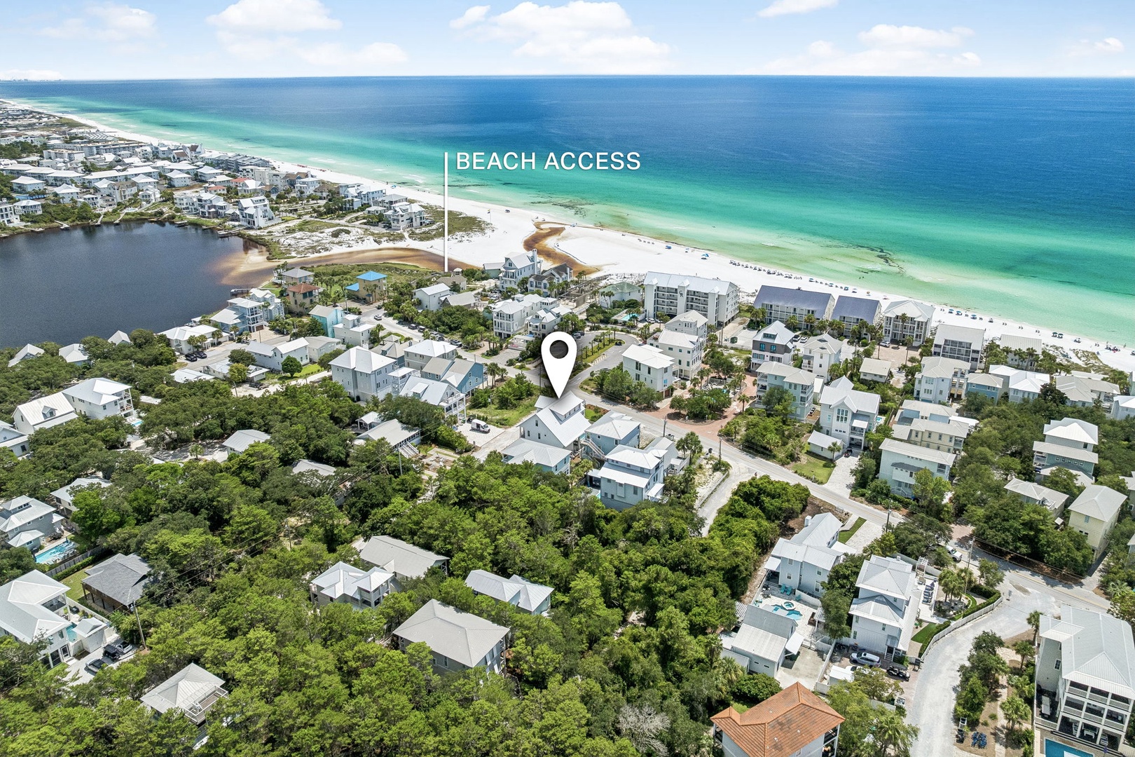 This aerial view shows the property's prime location in a coastal residential community, just a short walk from pristine white-sand beaches and turquoise waters.