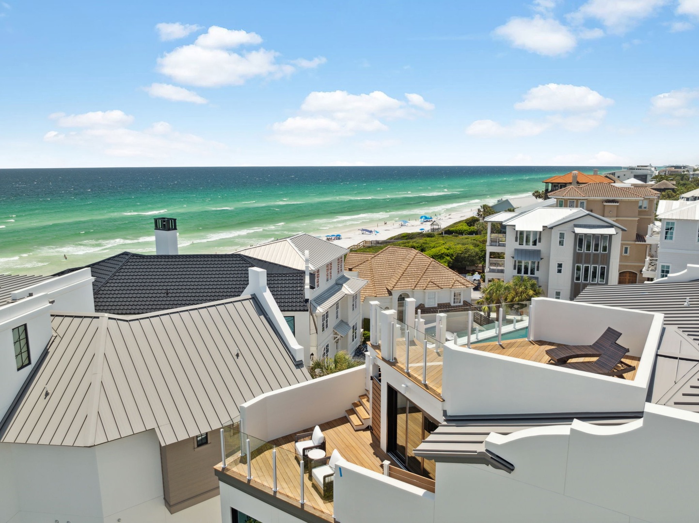 Elevated coastal neighborhood showcasing beach-adjacent properties with stunning emerald waters and sugar-white sand. A prime beachfront location offering direct access to pristine shores and scenic Gulf views.