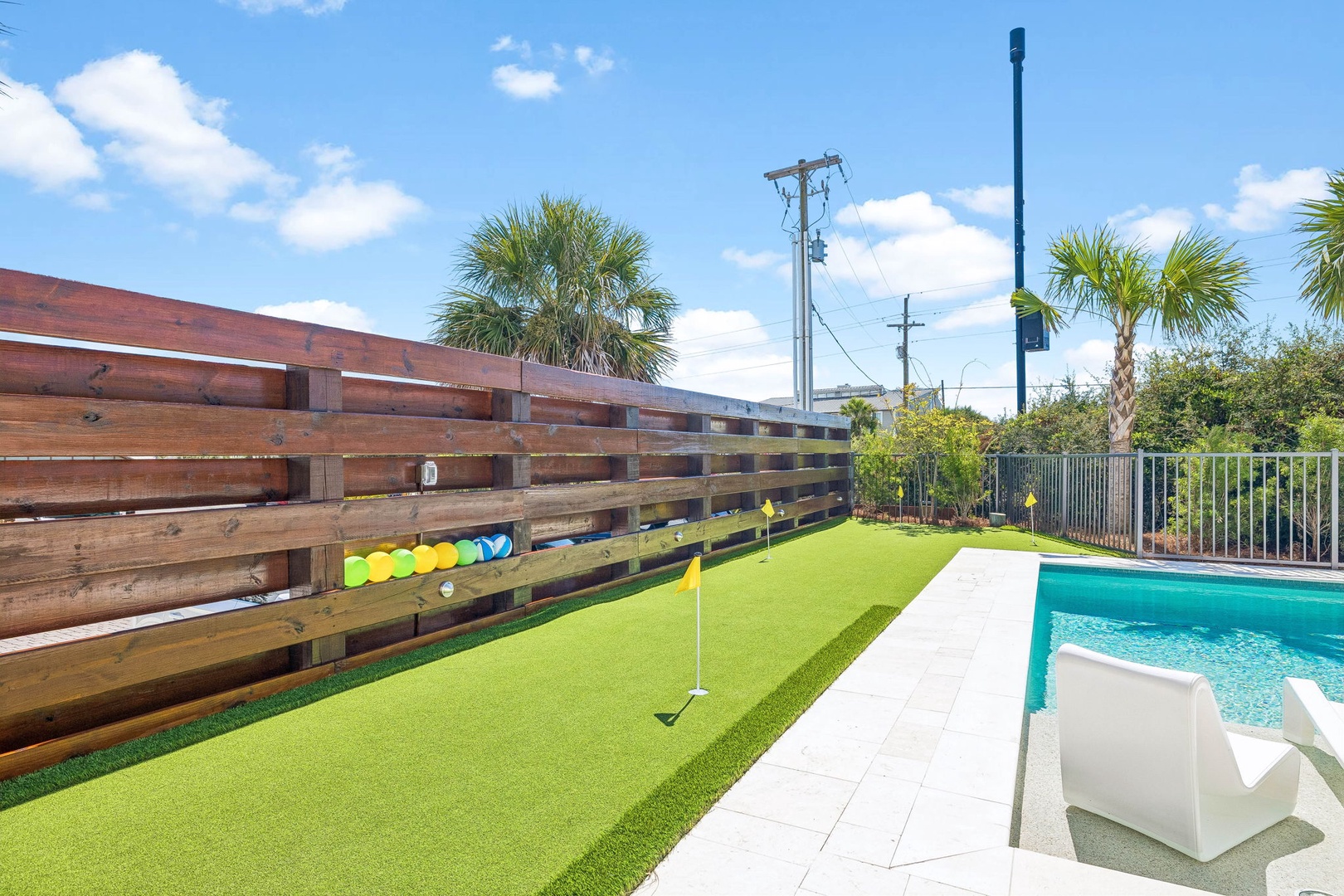 This property features a private backyard putting green and sparkling pool, perfect for outdoor fun and relaxation under the Florida sun.