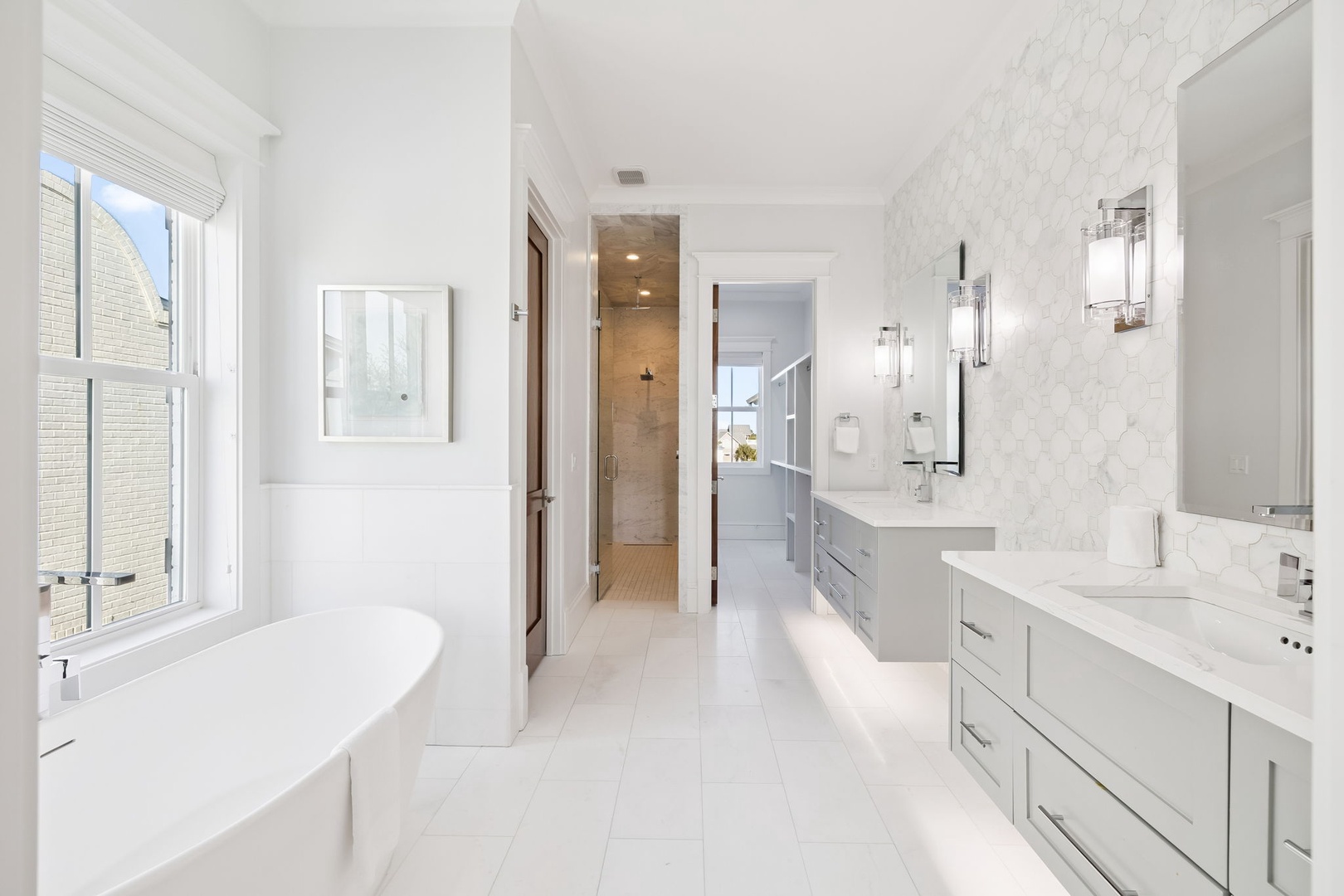 Step into your luxurious spa-like bathroom with elegant marble details, soaking tub, and spacious double vanity perfect for unwinding.