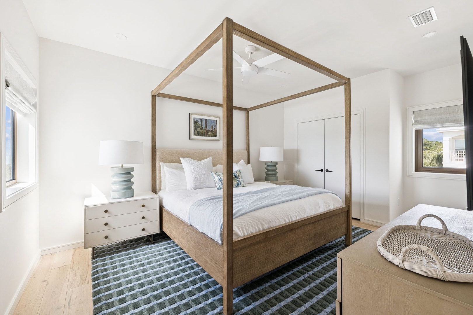Unwind in your elegant four-poster sanctuary with crisp linens and coastal views streaming through bright windows.