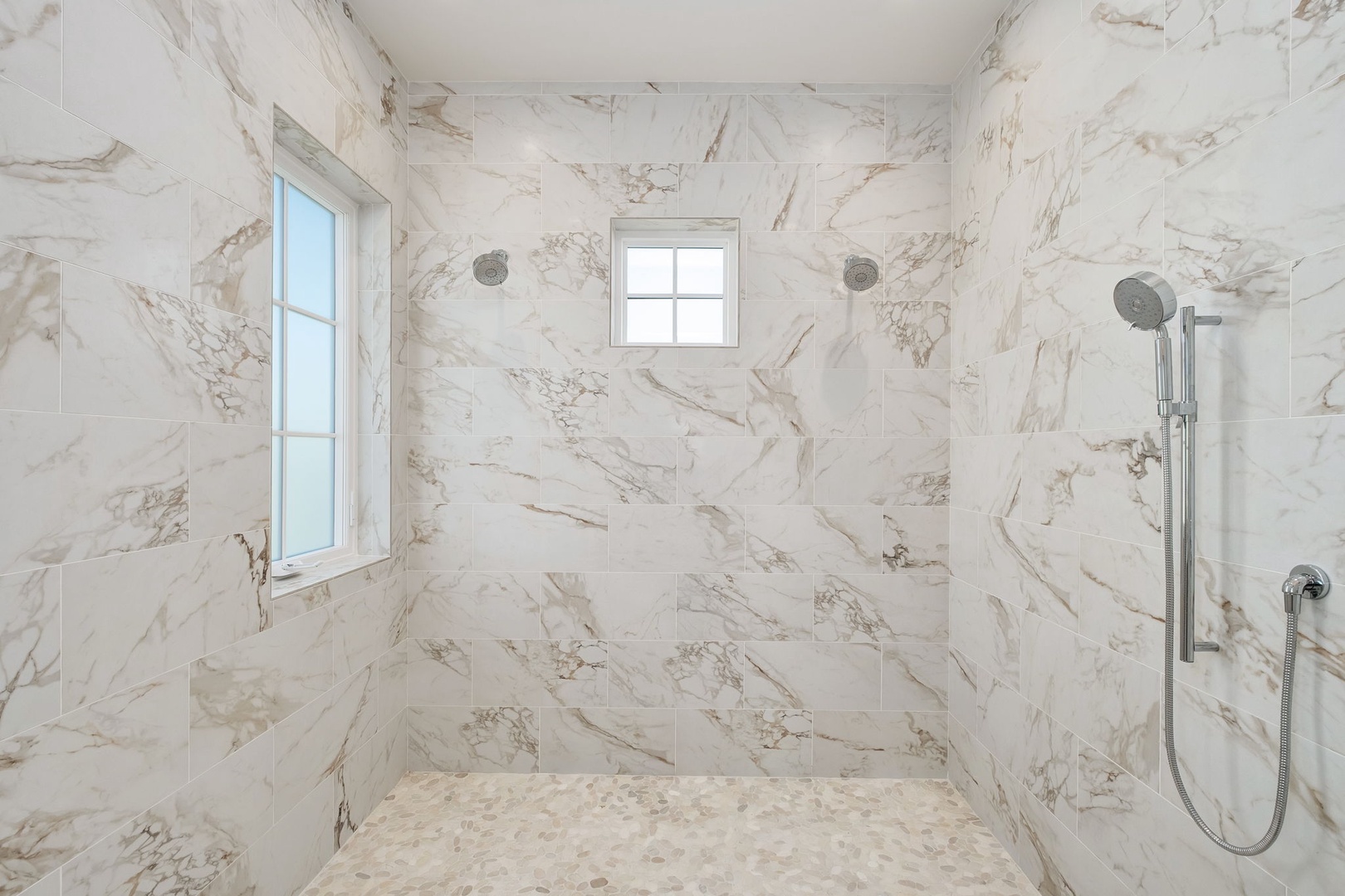 Step into your marble sanctuary where elegant natural stone surrounds you, creating a spa-like retreat with modern fixtures and serene natural light.