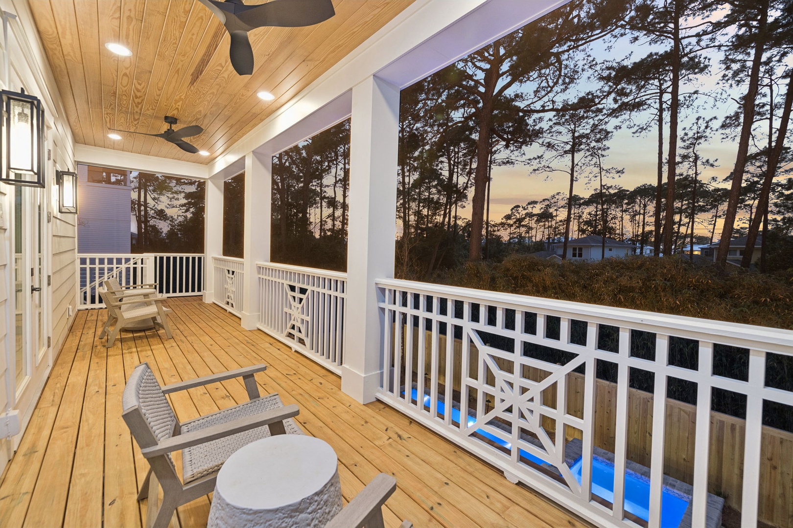 Relax on your private covered porch with ceiling fans and cozy seating while overlooking peaceful wooded surroundings.
