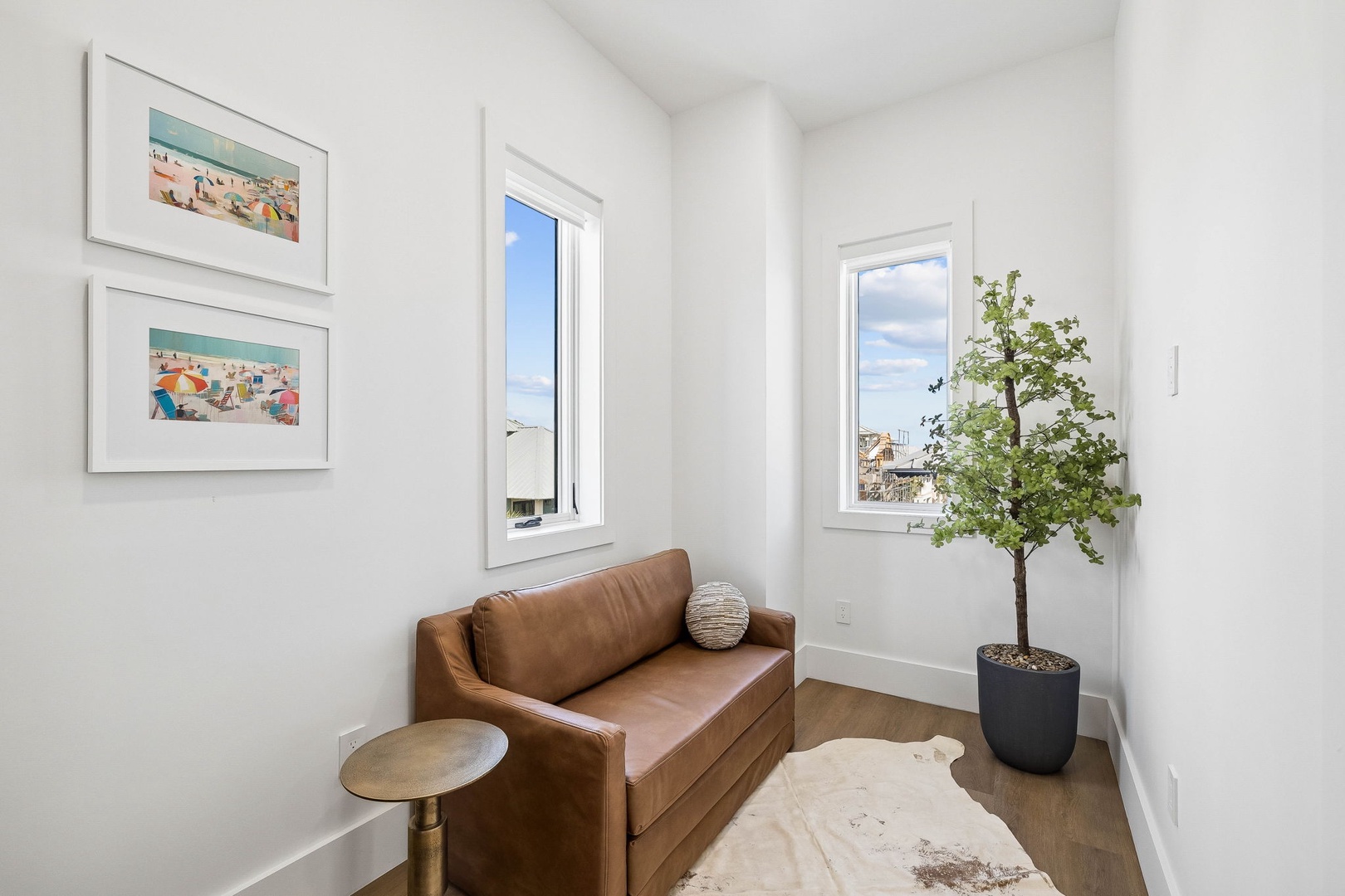 Relax in your private lounge with a cozy leather loveseat and bright natural light streaming through large windows. A peaceful spot to unwind and enjoy the view.