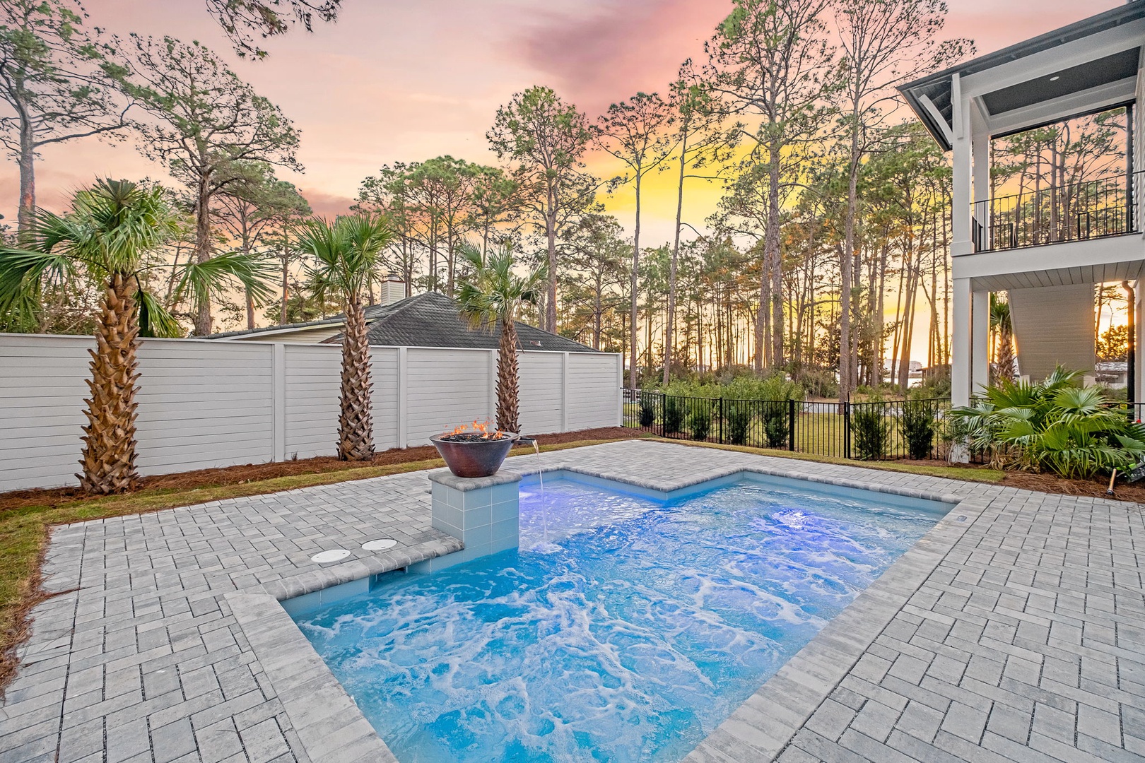 Soak in your private hot tub as golden sunlight filters through towering pines, creating the perfect evening retreat.