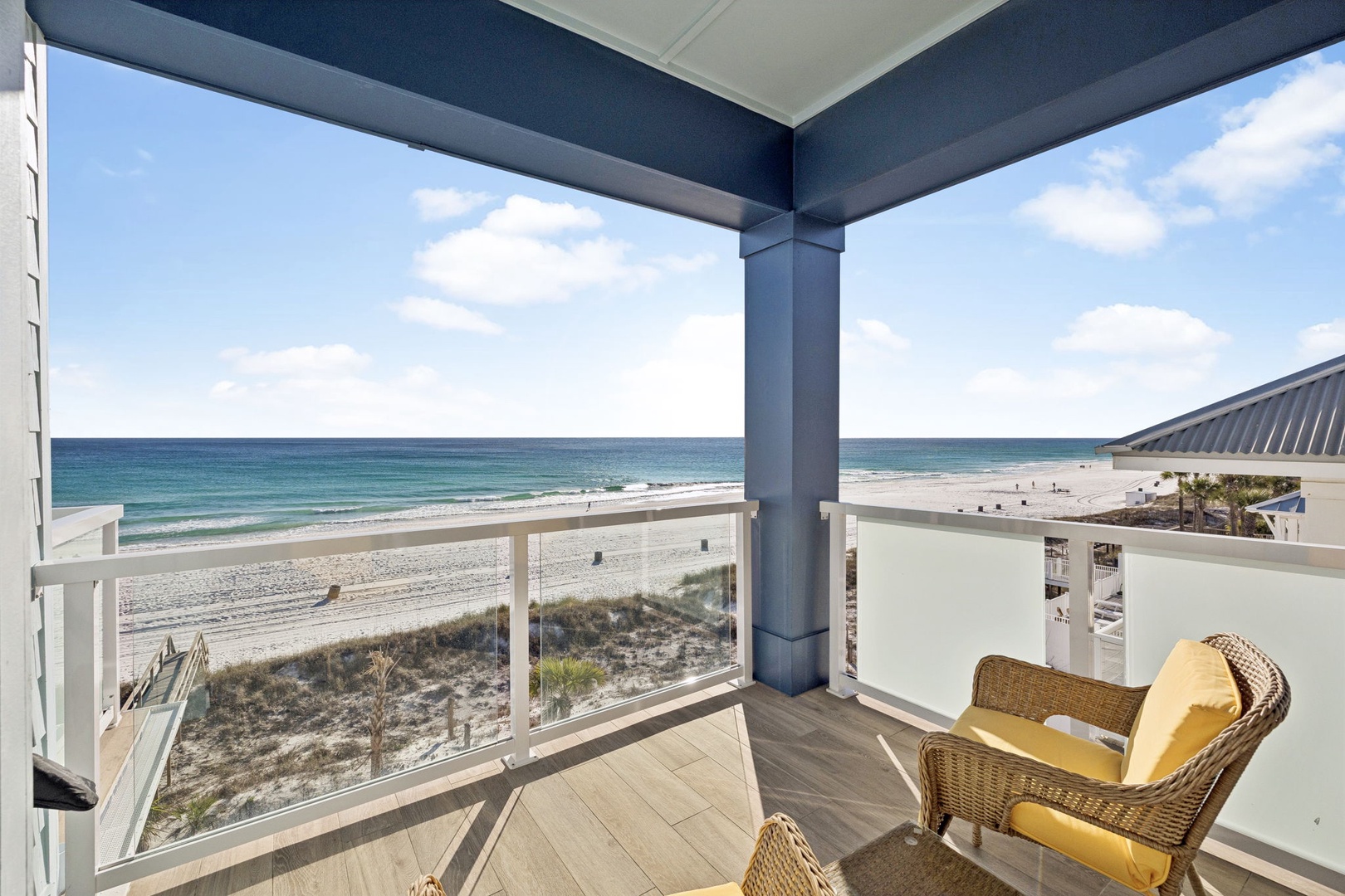 Unwind in your private beachfront sanctuary with panoramic ocean views and cozy wicker seating.