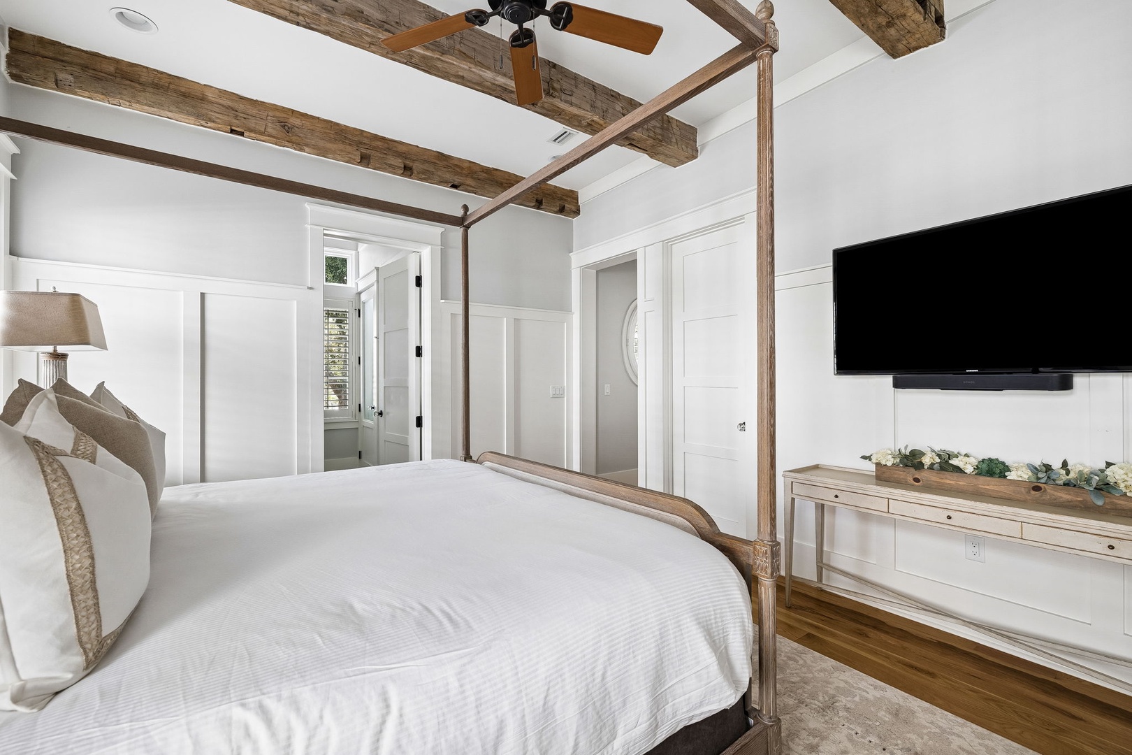 Drift into restful sleep beneath charming rustic beams in your elegant canopy bed, where farmhouse style meets modern comfort. Crisp white linens and soft, natural textures invite you to unwind after a day of adventure.