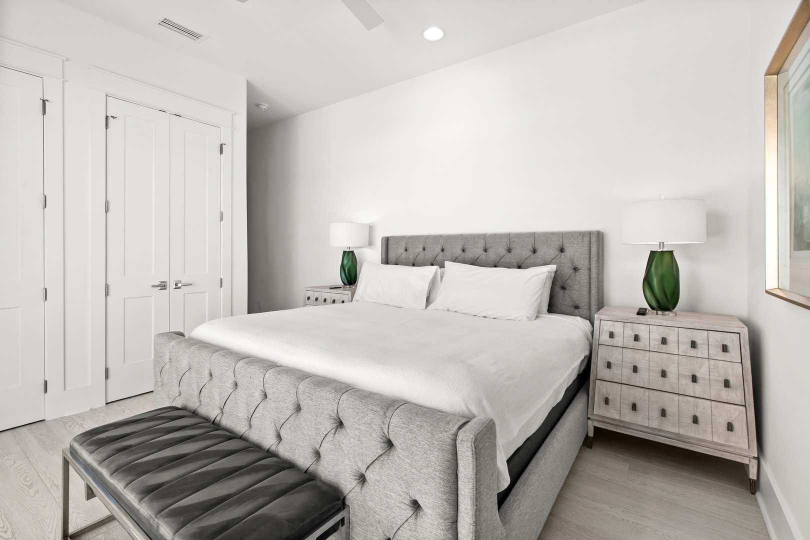 Slip into your peaceful retreat, where a plush bed and elegant furnishings await your restful nights in a serene, light-filled sanctuary.