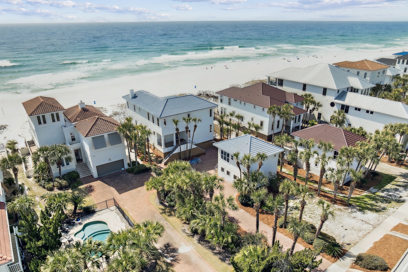 Stunning beachfront vacation homes with pristine white sand beach and turquoise waters just steps away from this coastal community.