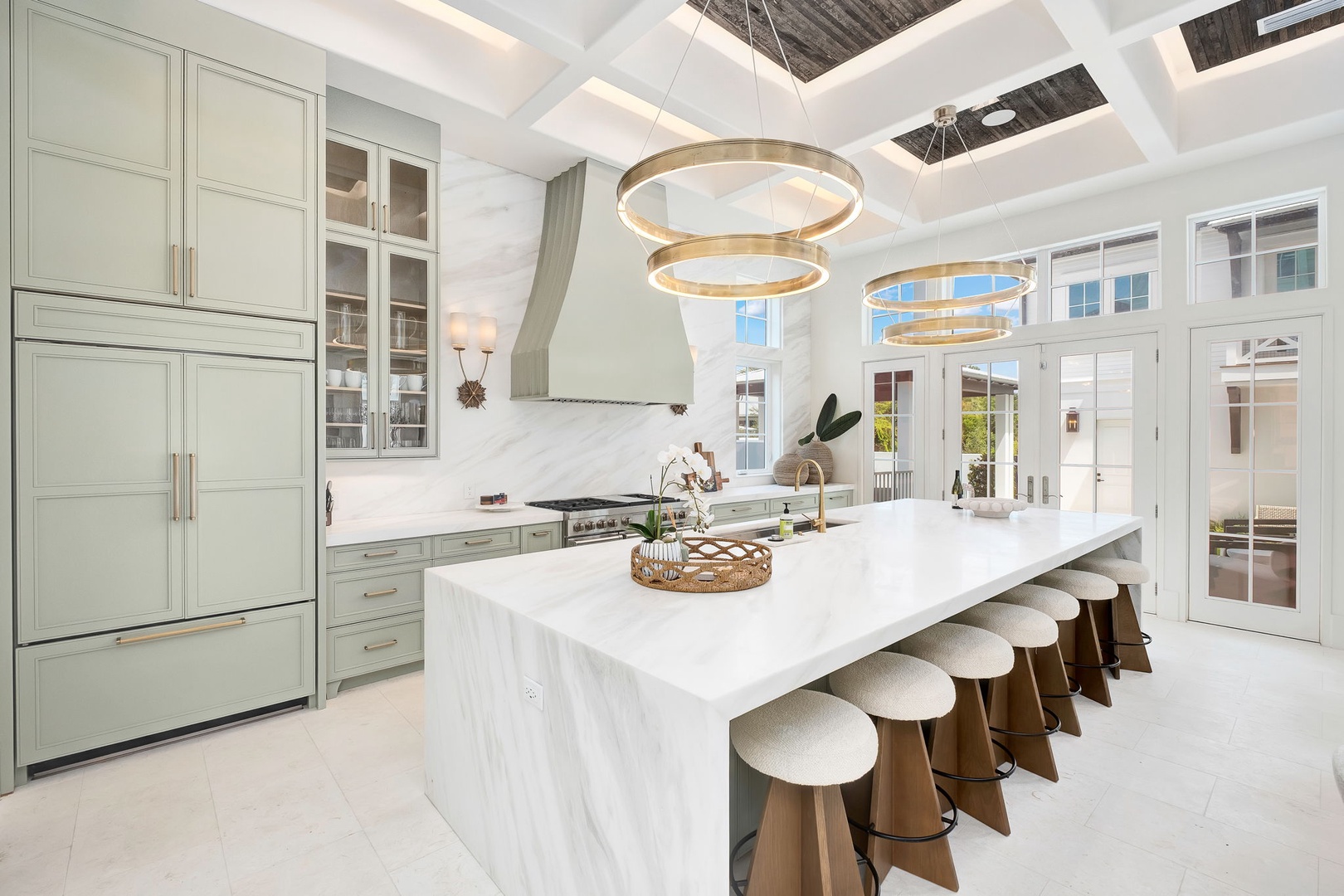 Cook up culinary masterpieces in this stunning gourmet kitchen, complete with marble waterfall island, top-tier appliances, and a skylight that bathes your space in warm natural light.