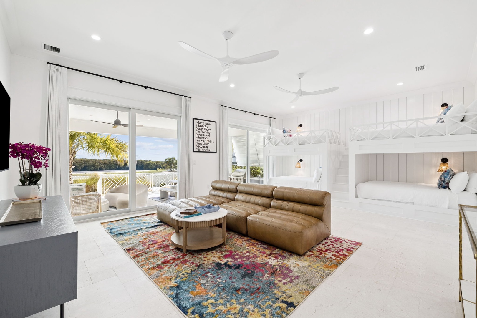 Sink into the plush leather sectional while tropical breezes flow through your bright, open living space with stunning lake views.