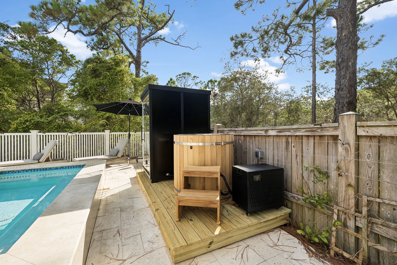 A poolside paradise awaits with an outdoor sauna, perfect for unwinding after a refreshing swim. Surrounded by tall pines and dappled sunlight, you'll find your own private wellness retreat right at home.