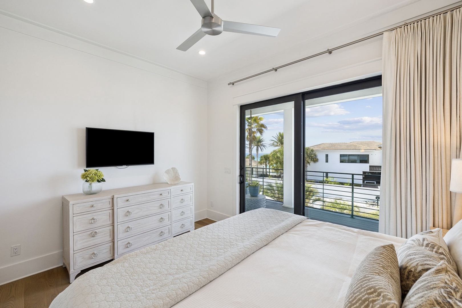 Wake up to gentle ocean breezes in your serene bedroom, where soft linens and tropical views create the perfect coastal retreat.