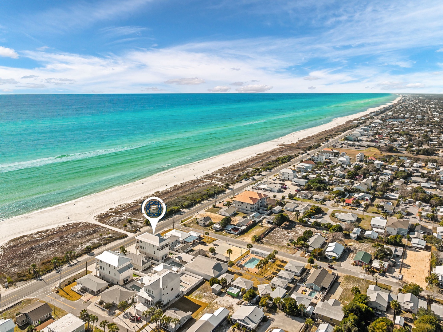Stunning aerial view showcasing the property's prime beachfront location with pristine white sand beach and crystal-clear turquoise waters just steps away.