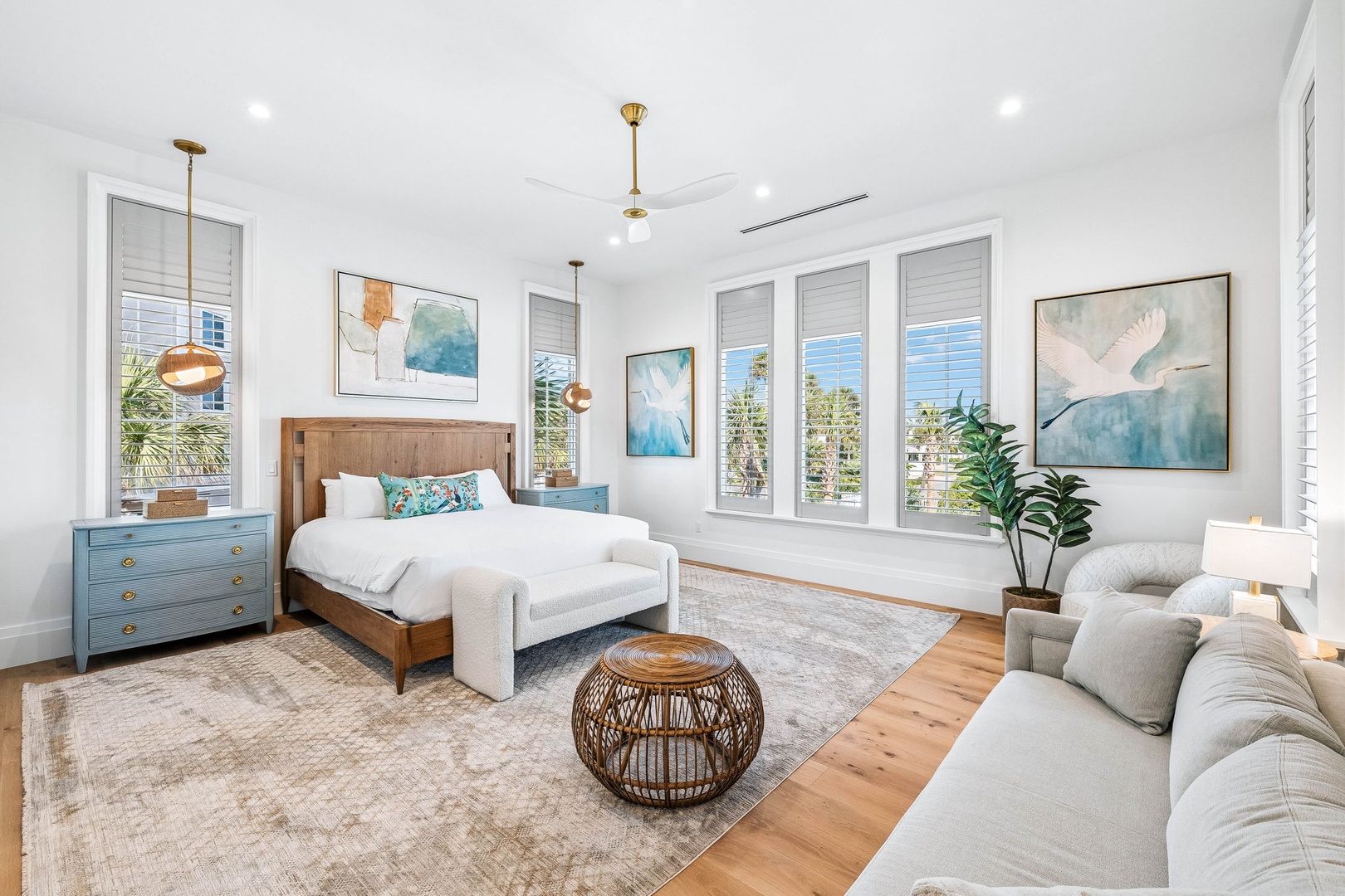 Sink into plush comfort and let natural light fill your airy bedroom retreat. Coastal-inspired artwork and warm wood touches create a serene space where you'll truly unwind.