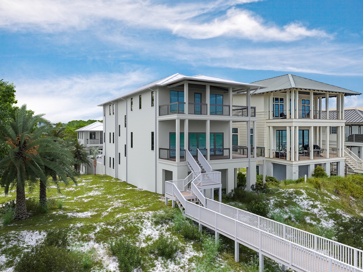 A stunning coastal property featuring modern architecture and elevated design, nestled among palm trees with a scenic boardwalk leading through natural dunes to the beach.