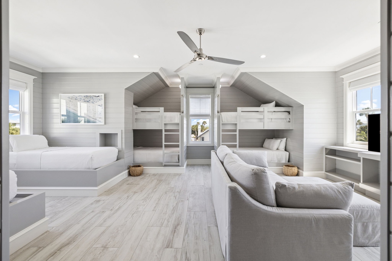 Sleep soundly in this charming bunk room where coastal design meets comfort. Four built-in beds create perfect family memories.