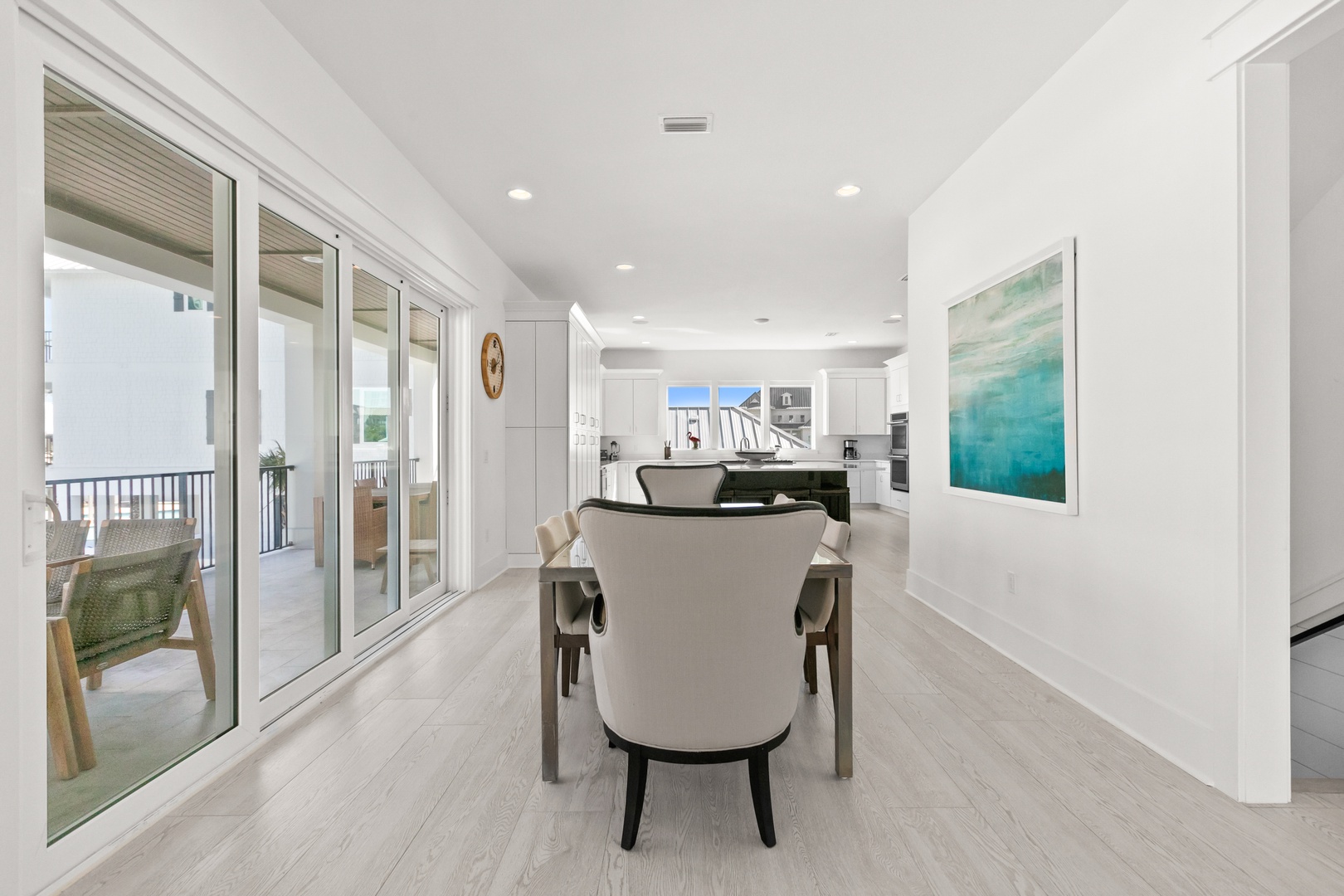 Step into your bright, open dining space, where coastal elegance meets everyday comfort. Large glass doors flood the area with natural light and open to your private balcony for fresh air and relaxation.