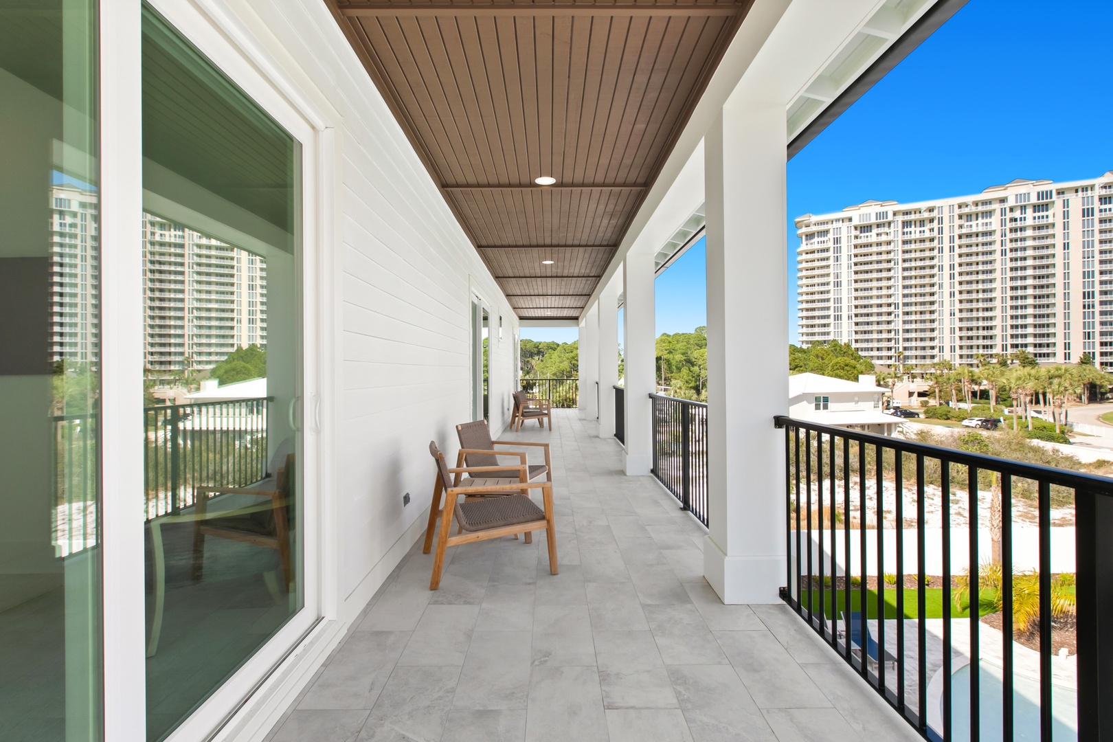 Step out onto your private balcony and soak in the warm sunshine. Two cozy chairs invite you to relax while taking in peaceful views of the surrounding neighborhood.