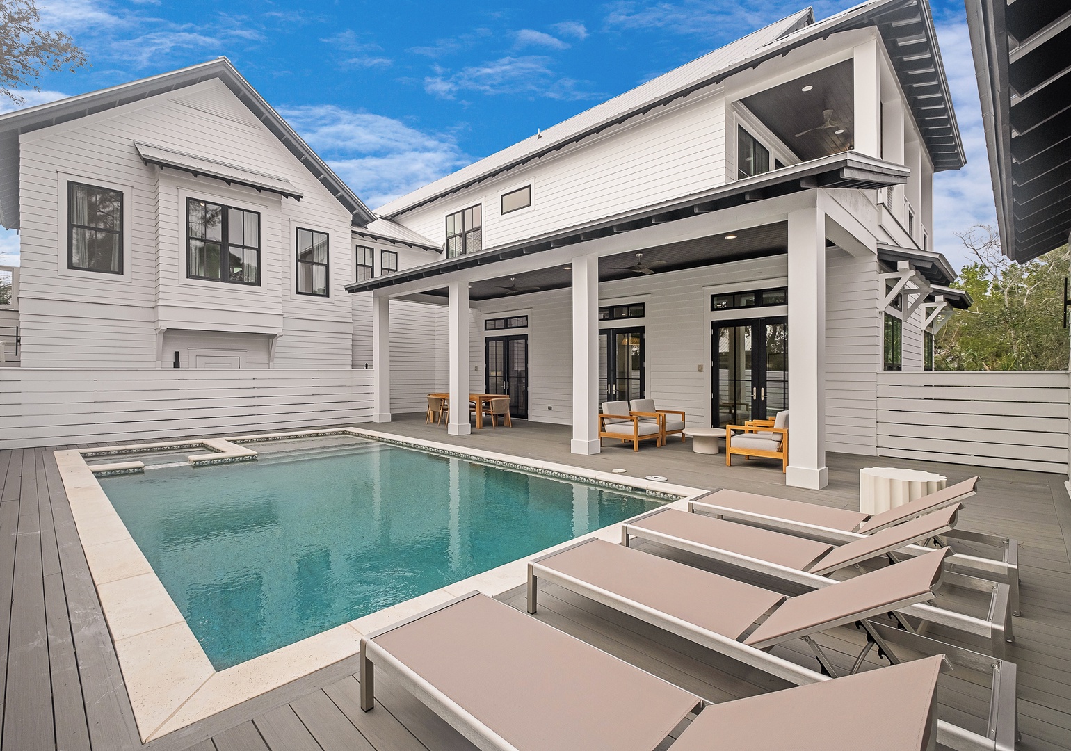 Dive into your private oasis with this stunning pool surrounded by modern comfort and elegant outdoor living spaces.