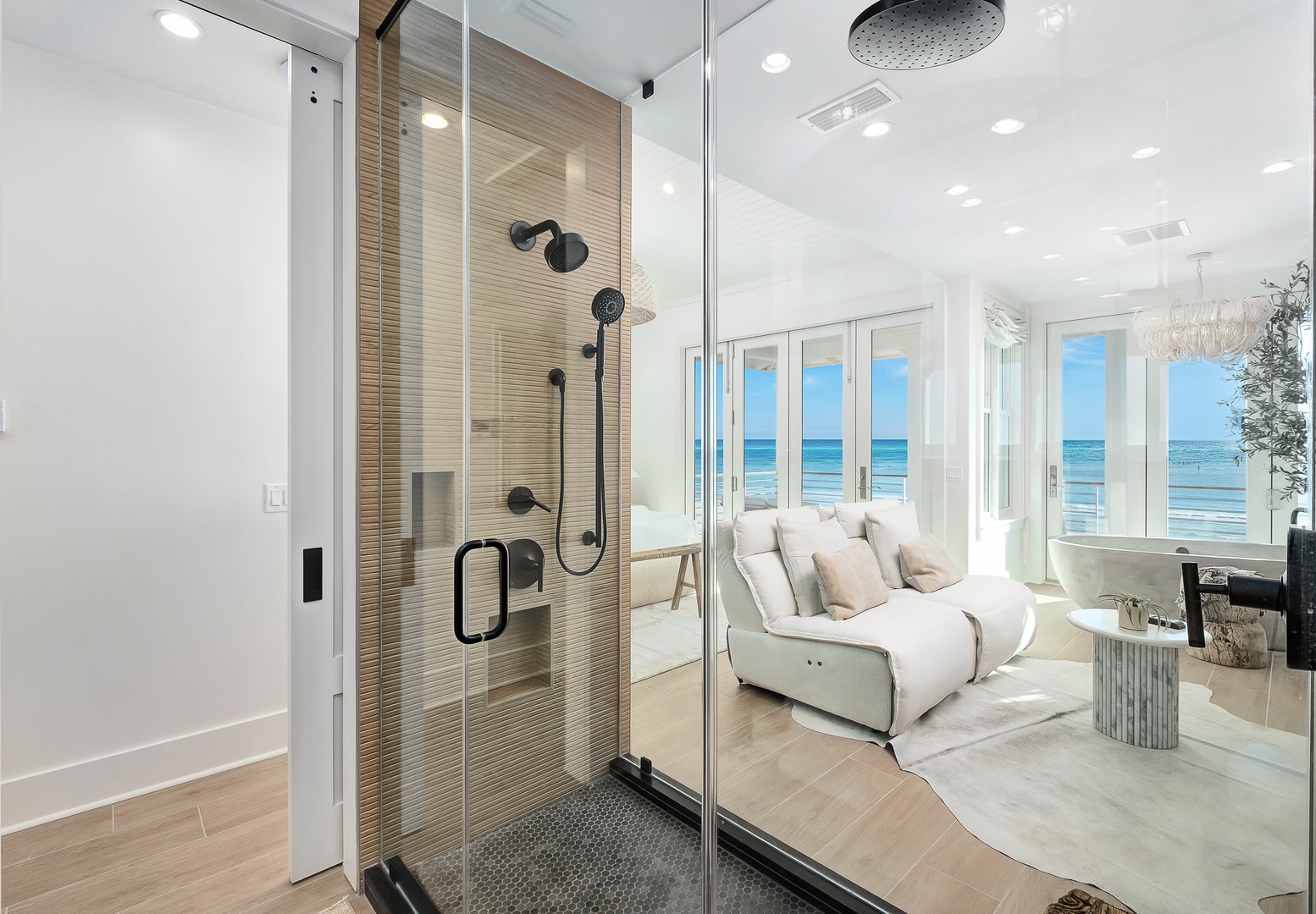 Step into your luxurious glass-enclosed shower with stunning ocean views, where modern elegance meets coastal serenity in every detail.