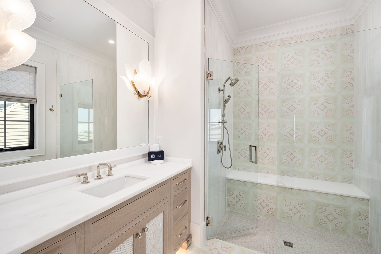 Luxuriate in your elegant bathroom with beautiful patterned tile, spacious shower, and sophisticated vanity—perfect for morning routines.
