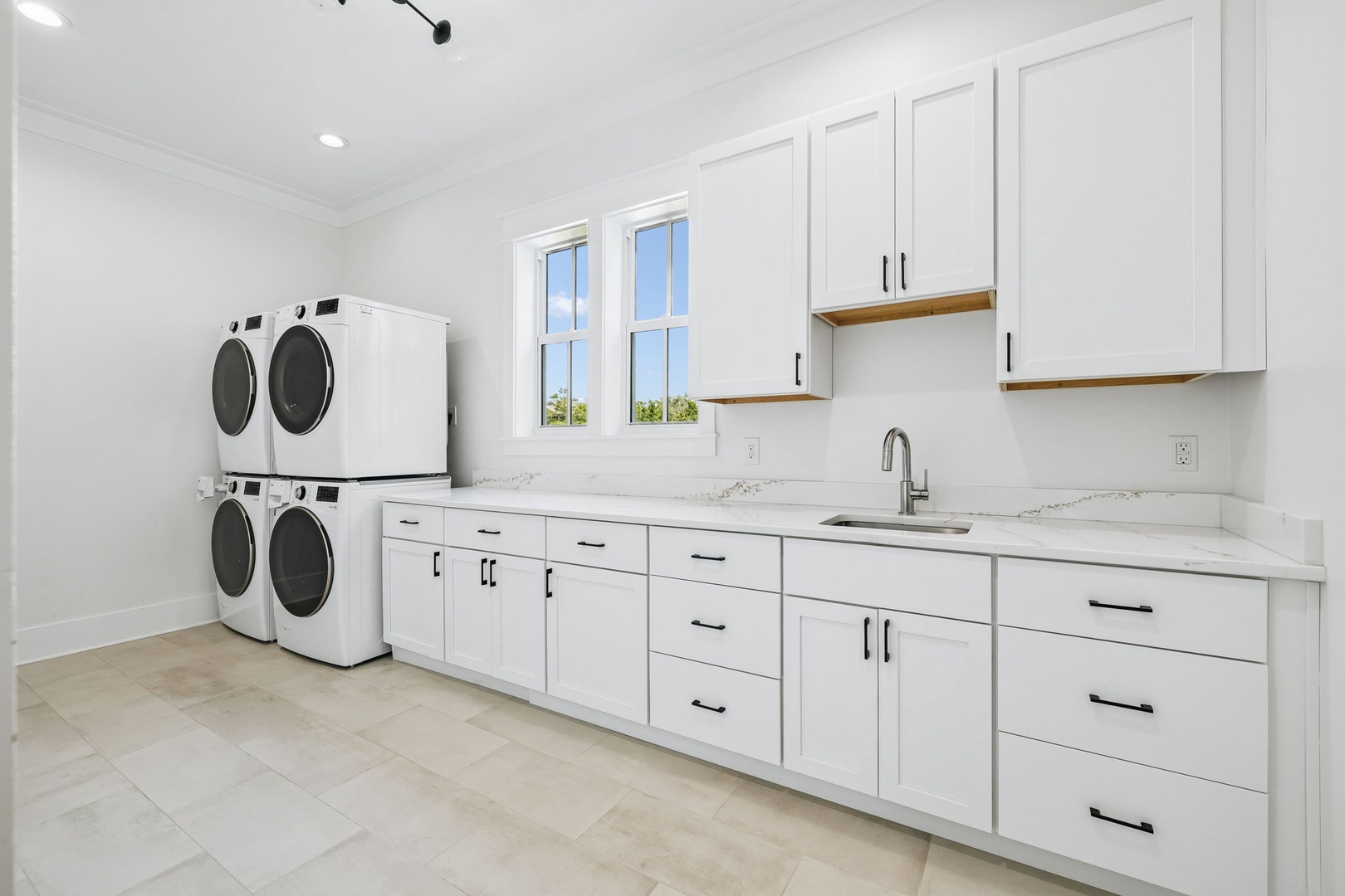 Enjoy your dedicated laundry room with dual washers and dryers, ample storage, and a handy sink for all your vacation needs.
