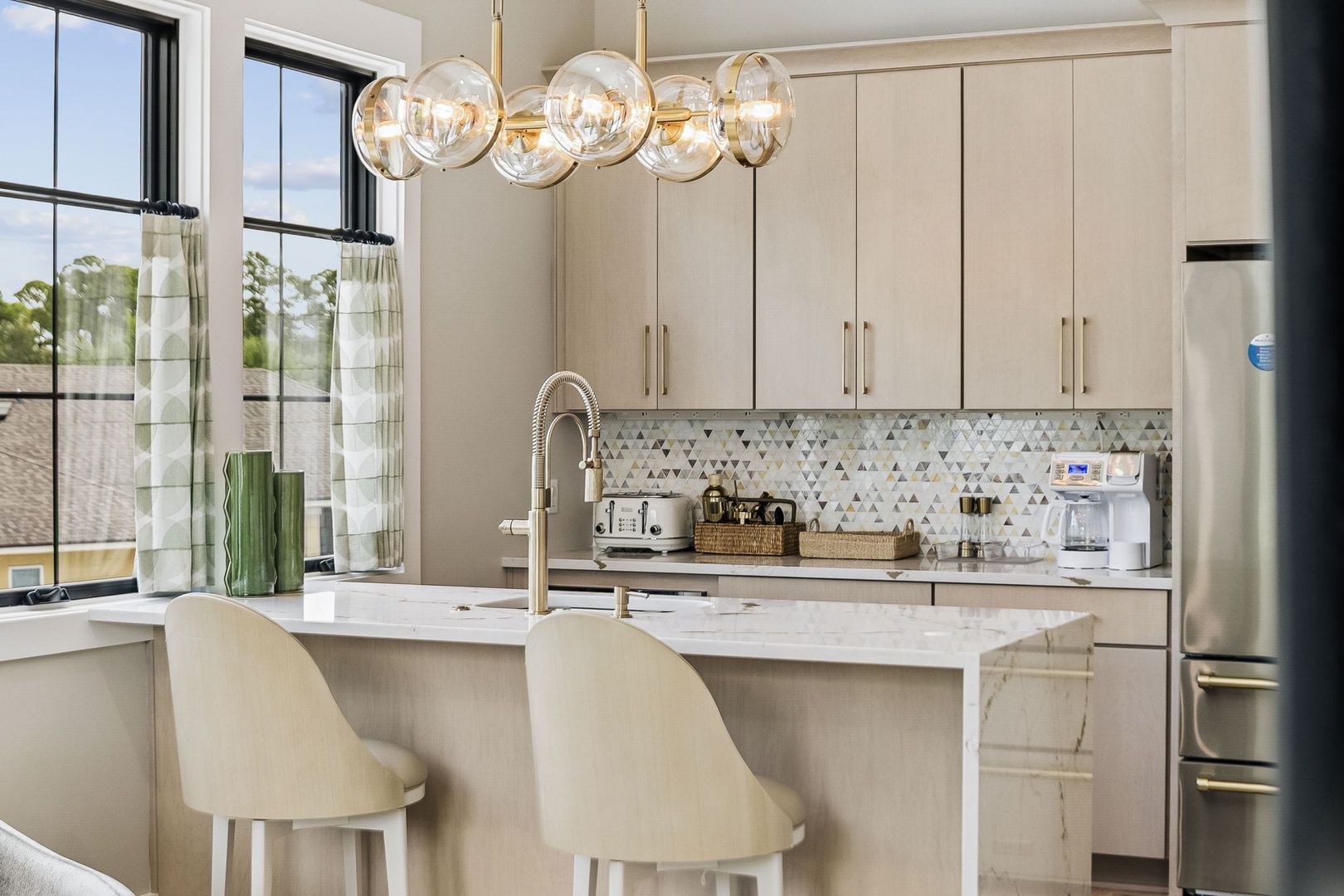 Your gourmet kitchen invites you to create and connect, with gleaming marble counters, elegant lighting, and a bright island perfect for morning coffee or evening gatherings.
