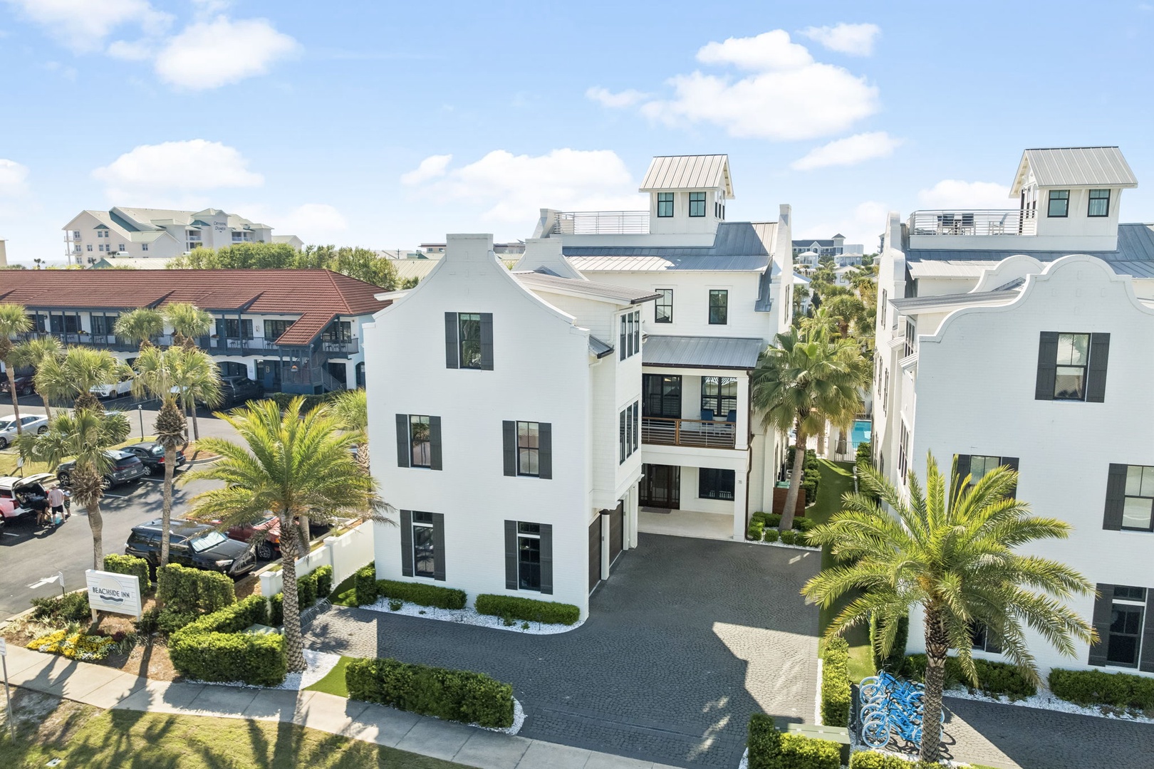 Modern coastal property featuring contemporary architecture with pristine landscaping and palm trees in a well-designed neighborhood setting.