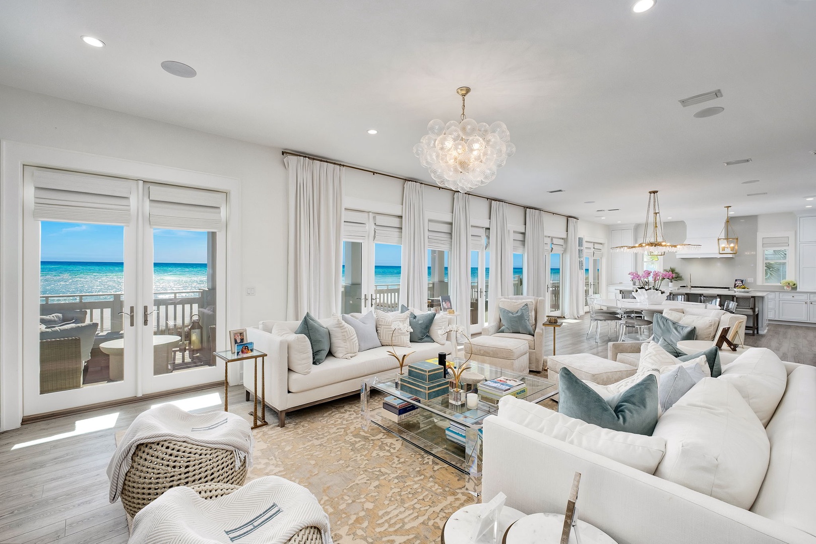 Picture yourself unwinding on plush sofas while gazing through floor-to-ceiling windows at stunning turquoise waters. This bright, elegant space flows seamlessly to your private deck, where ocean breezes and coastal serenity await.