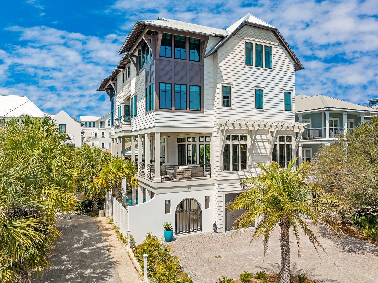 A stunning coastal property featuring elegant architecture and tropical landscaping in a peaceful beachside neighborhood.