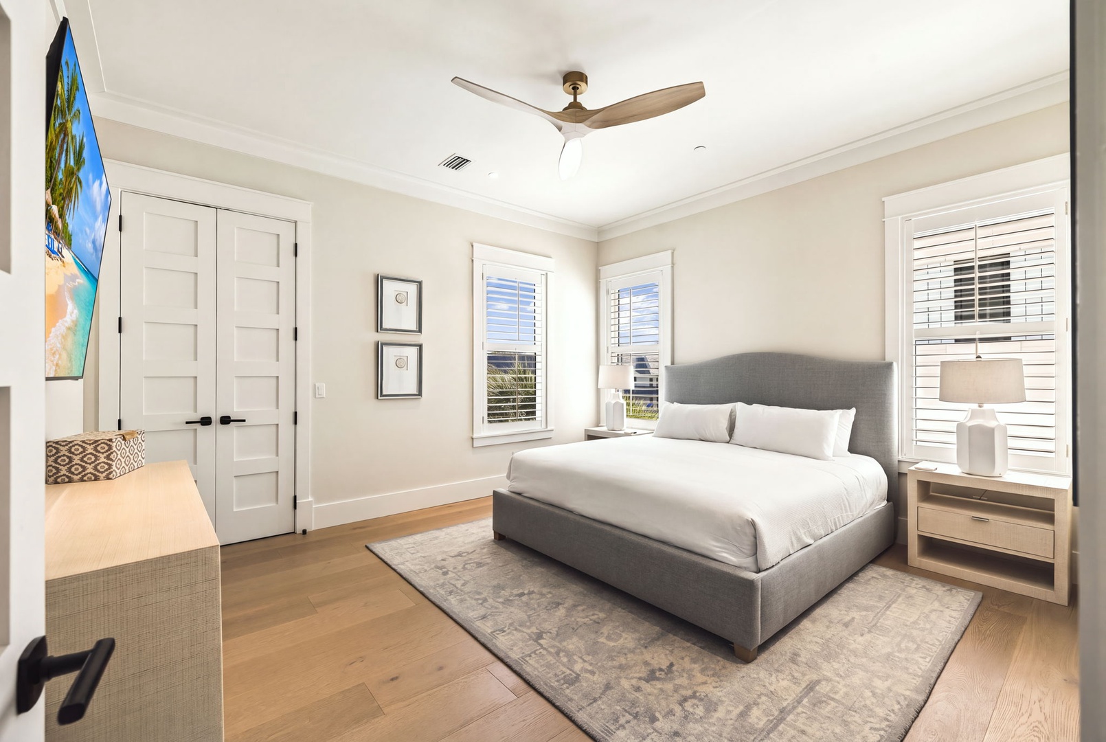 Slip into crisp white linens and let the ceiling fan's gentle breeze lull you to rest after a day of coastal adventures.