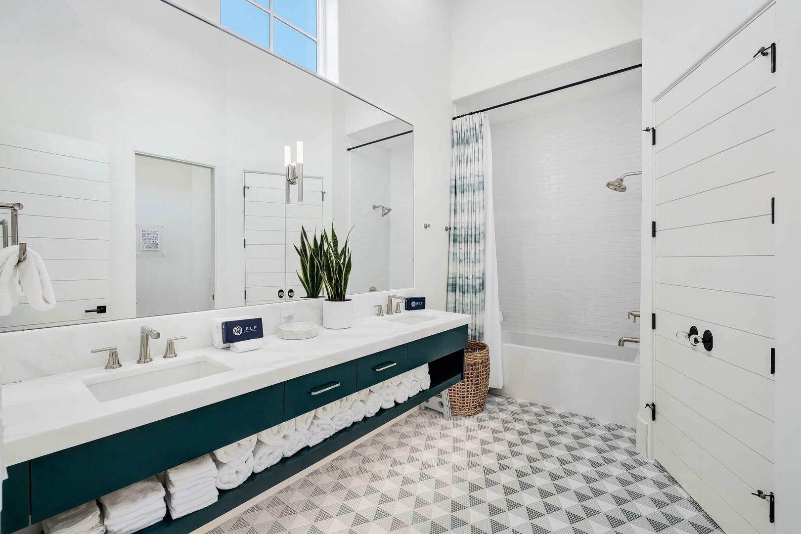 Step into your bright, spacious bathroom with dual sinks, fresh towels, and a relaxing tub-shower combo—a serene retreat after a day of exploring.