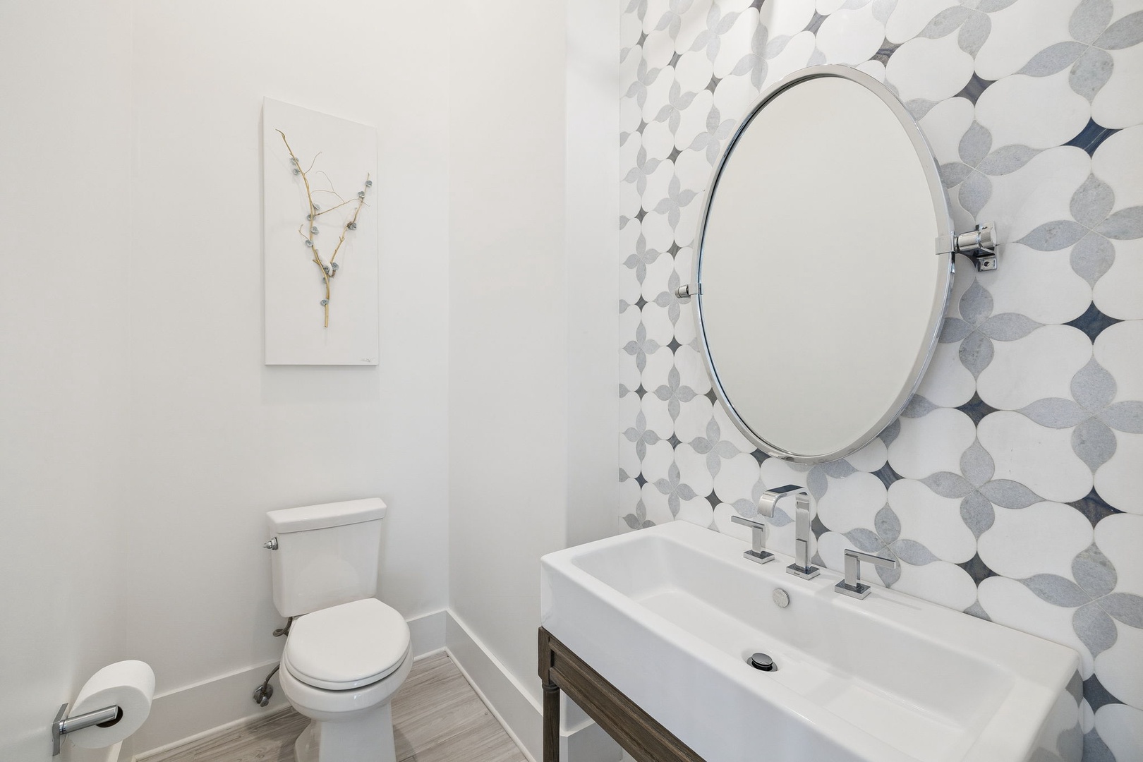 Step into your stylish powder room featuring elegant geometric wallpaper and modern fixtures for convenient refreshing moments.