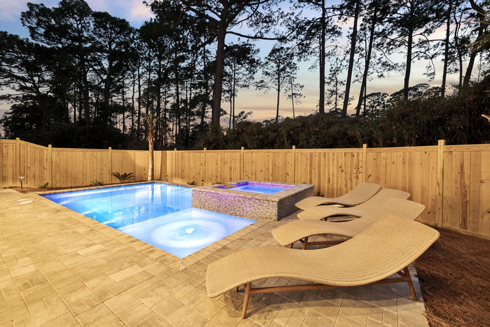 Your private pool and spa await, surrounded by towering pines and warm evening light—perfect for unwinding after exploring.