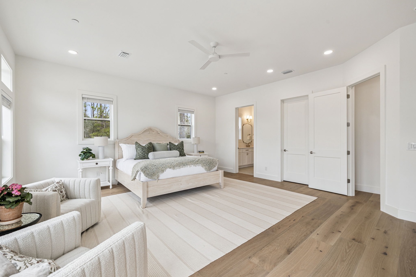 Drift into peaceful dreams in your bright, airy bedroom with soft linens and a cozy seating area for morning coffee.