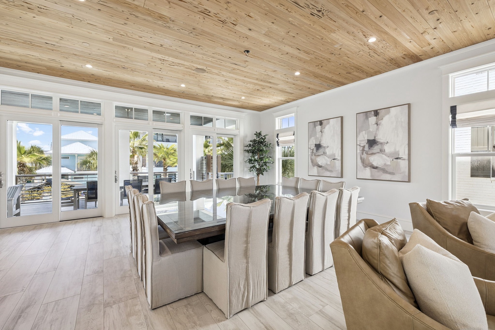 Gather around this elegant dining table under warm wood ceilings, where every meal becomes memorable with tropical views.