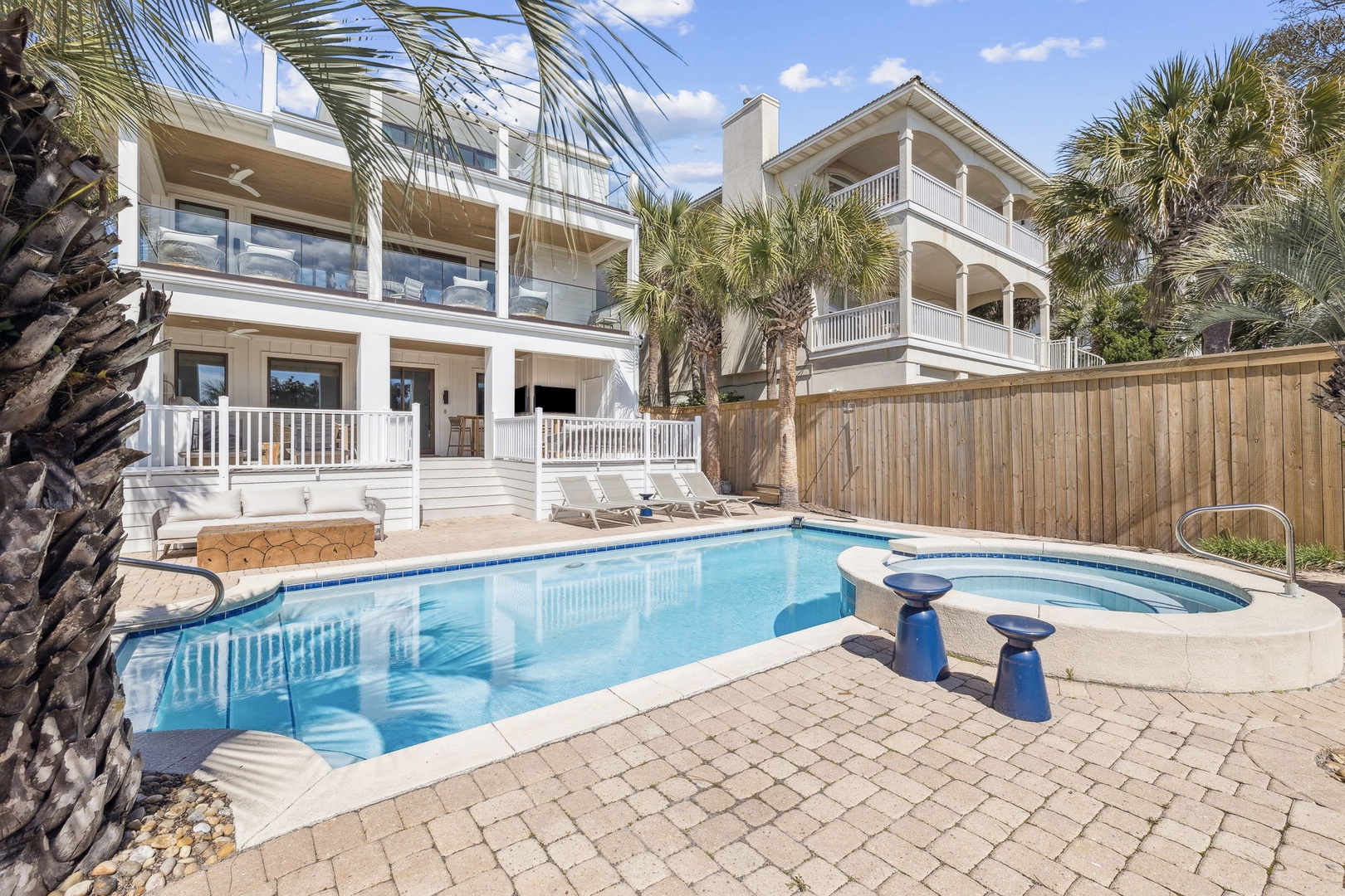 Dive into your private oasis with sparkling pool and spa, surrounded by swaying palms and spacious decks perfect for lounging.
