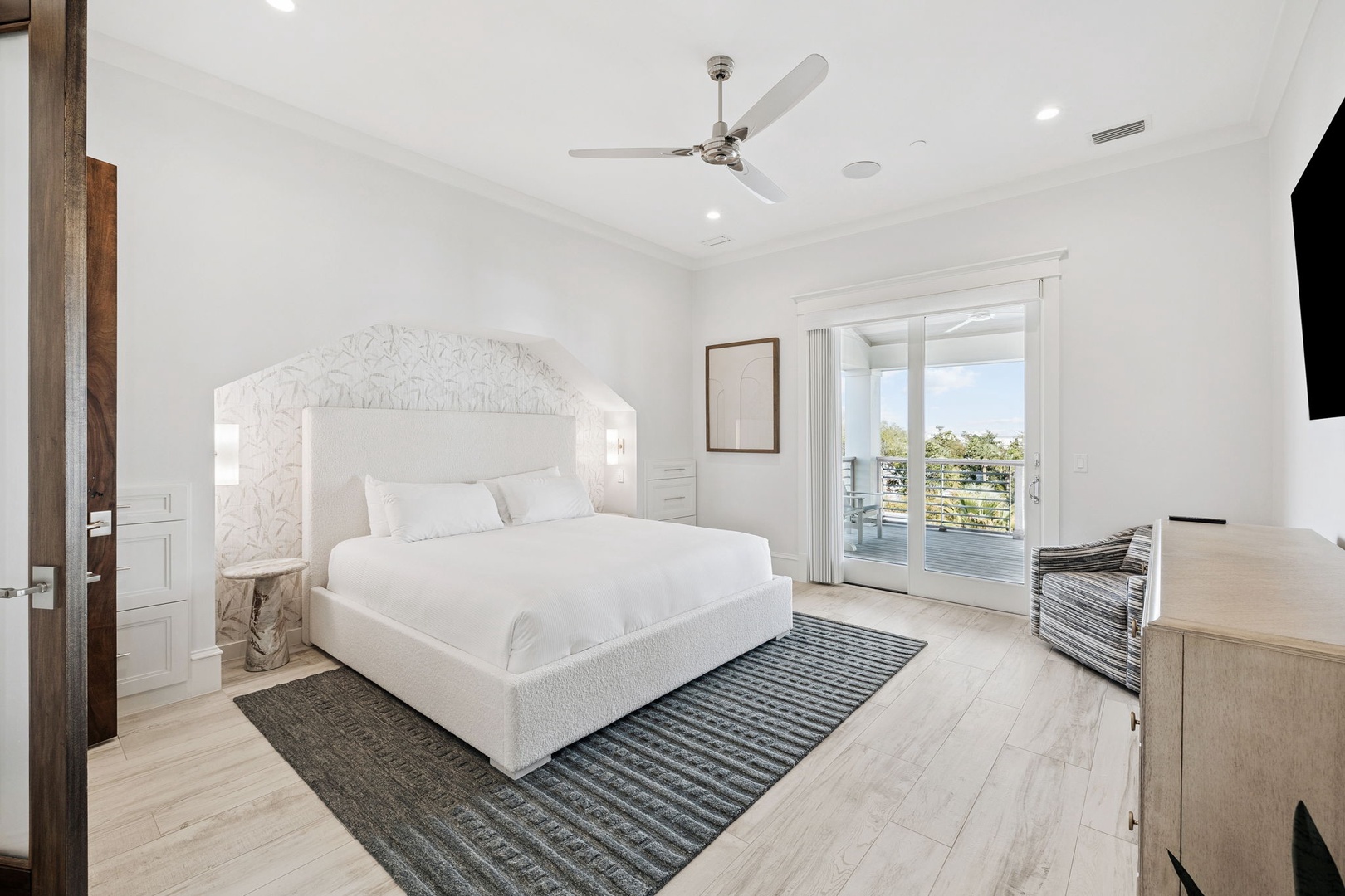 Drift off in your serene bedroom sanctuary, where crisp linens and gentle ceiling fan breezes create the perfect sleep haven.