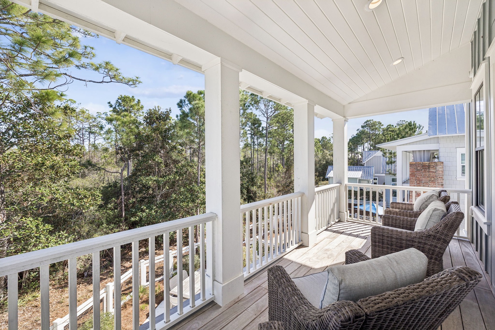 Your private porch oasis awaits with plush wicker seating and peaceful treetop views for morning coffee or evening relaxation.