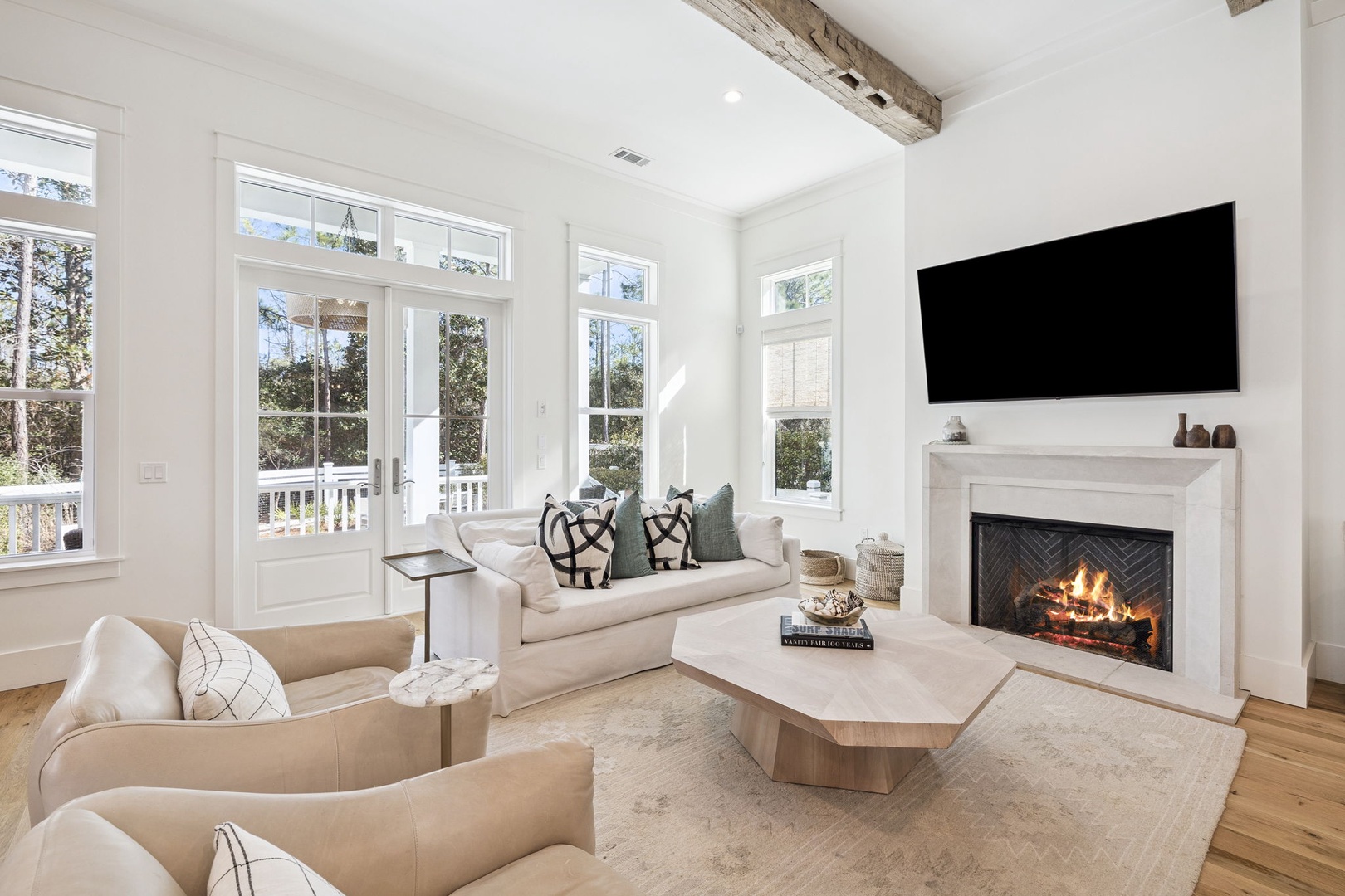 Unwind in your elegant living room where exposed beams meet modern comfort. Cozy up by the crackling fireplace while streaming shows.