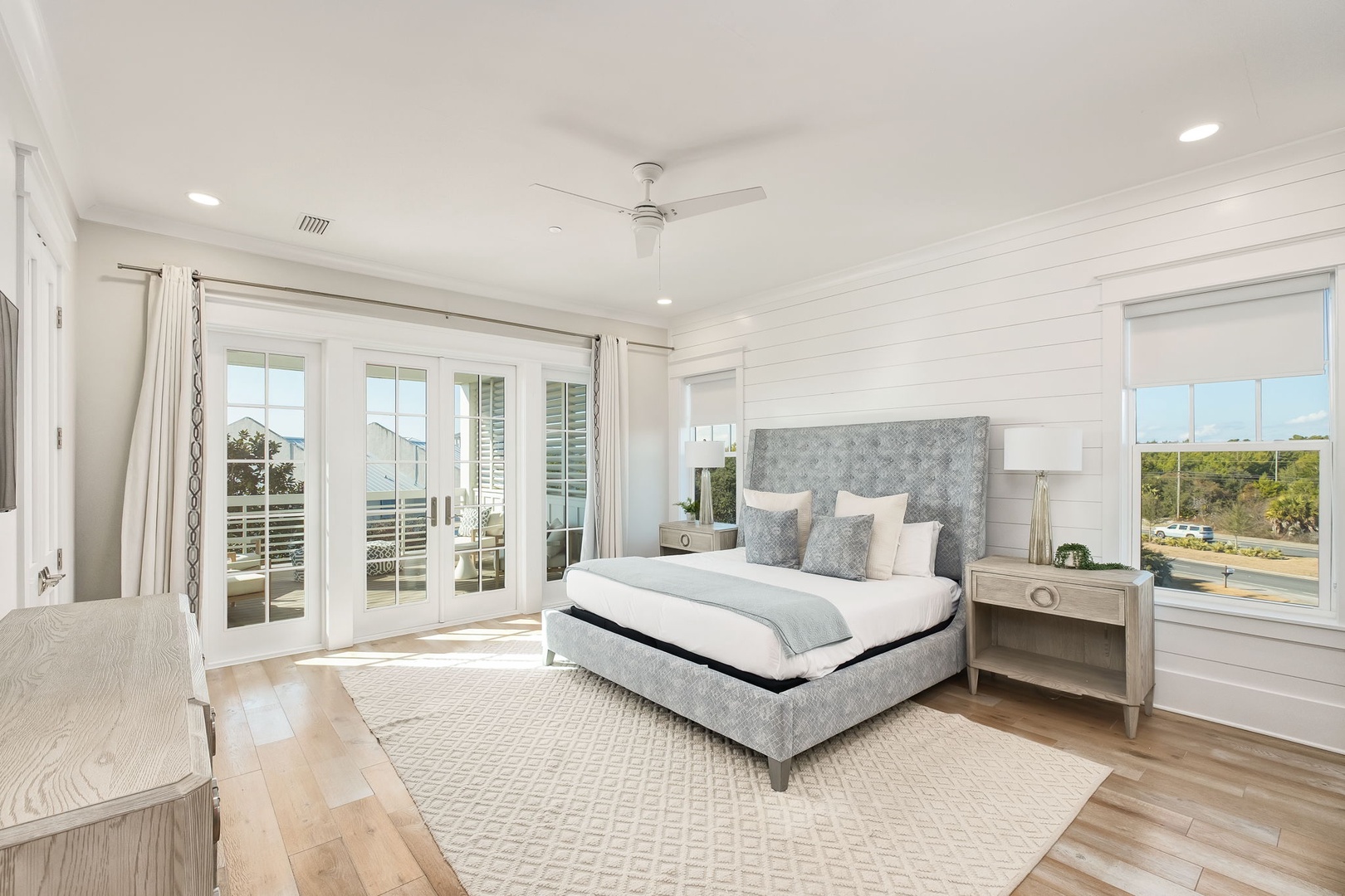 Rest peacefully in this elegant bedroom with soft linens and natural light streaming through French doors to your private balcony.