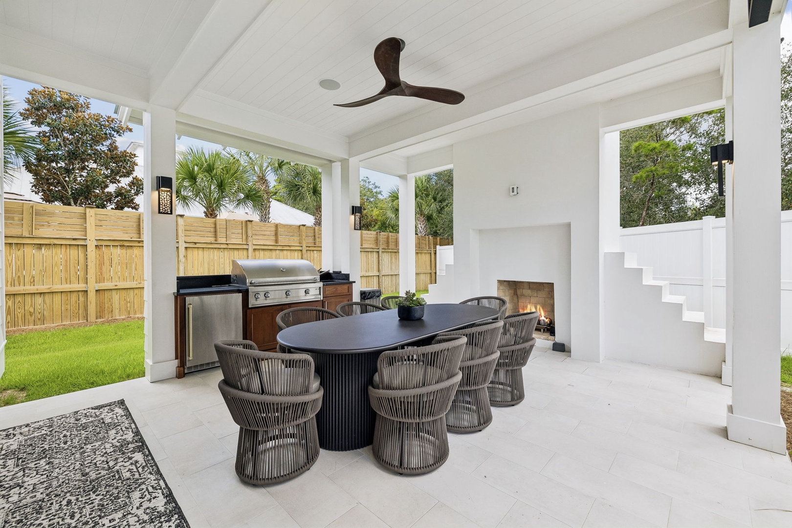 Step into your private outdoor oasis where dining and relaxation blend seamlessly. Fire up the grill, gather around the table with loved ones, or unwind by the cozy fireplace beneath the ceiling fan as evening settles in.