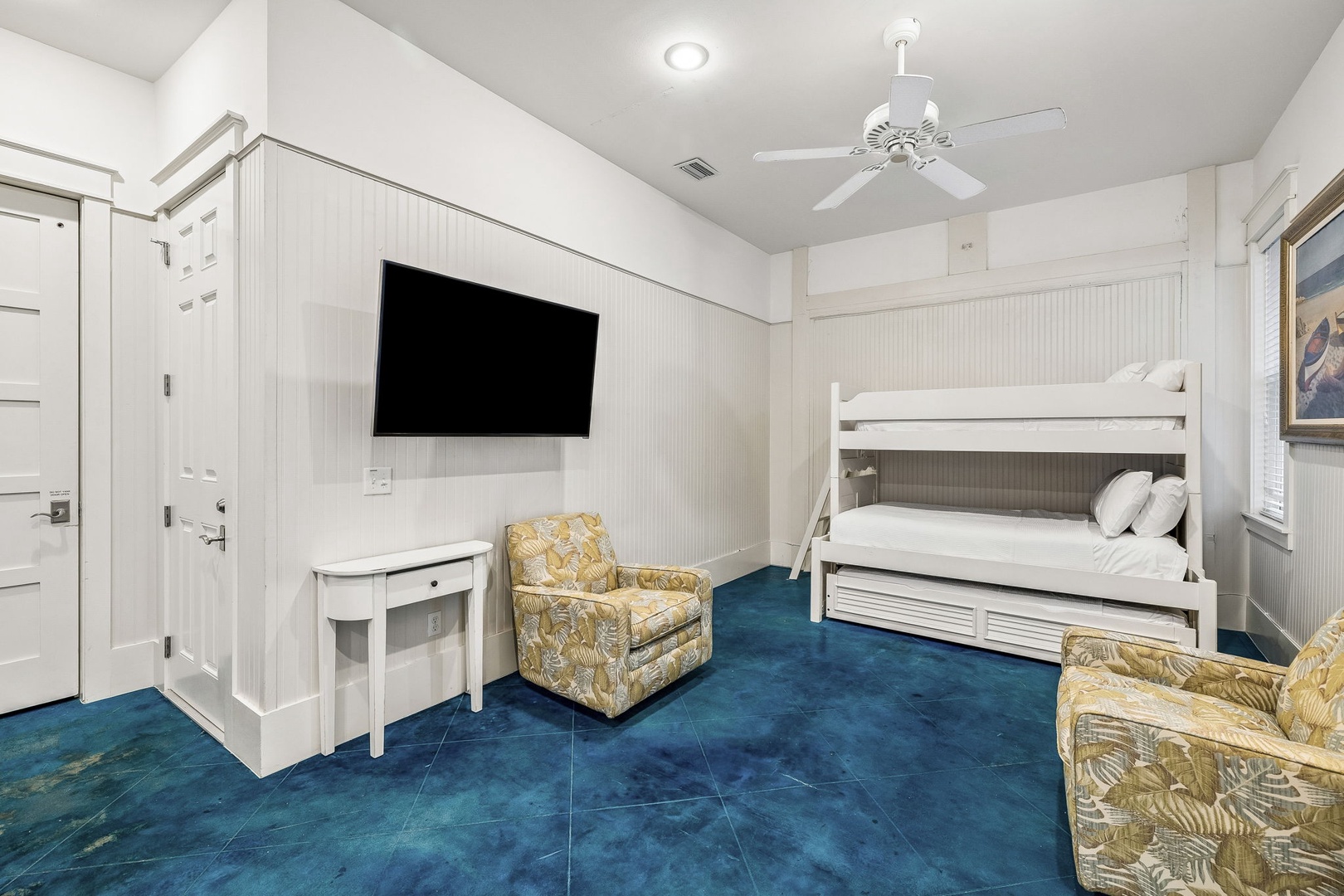 Gather the whole crew in this cozy bunk room, where crisp white linens meet coastal charm and everyone has their own comfy corner to unwind after a day of adventure.