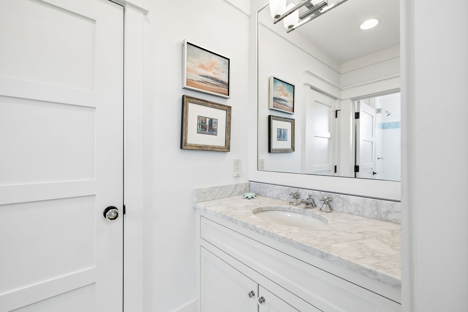 Freshen up in your elegantly appointed bathroom, where marble countertops and crisp white cabinetry create a peaceful retreat with thoughtful details at every turn.